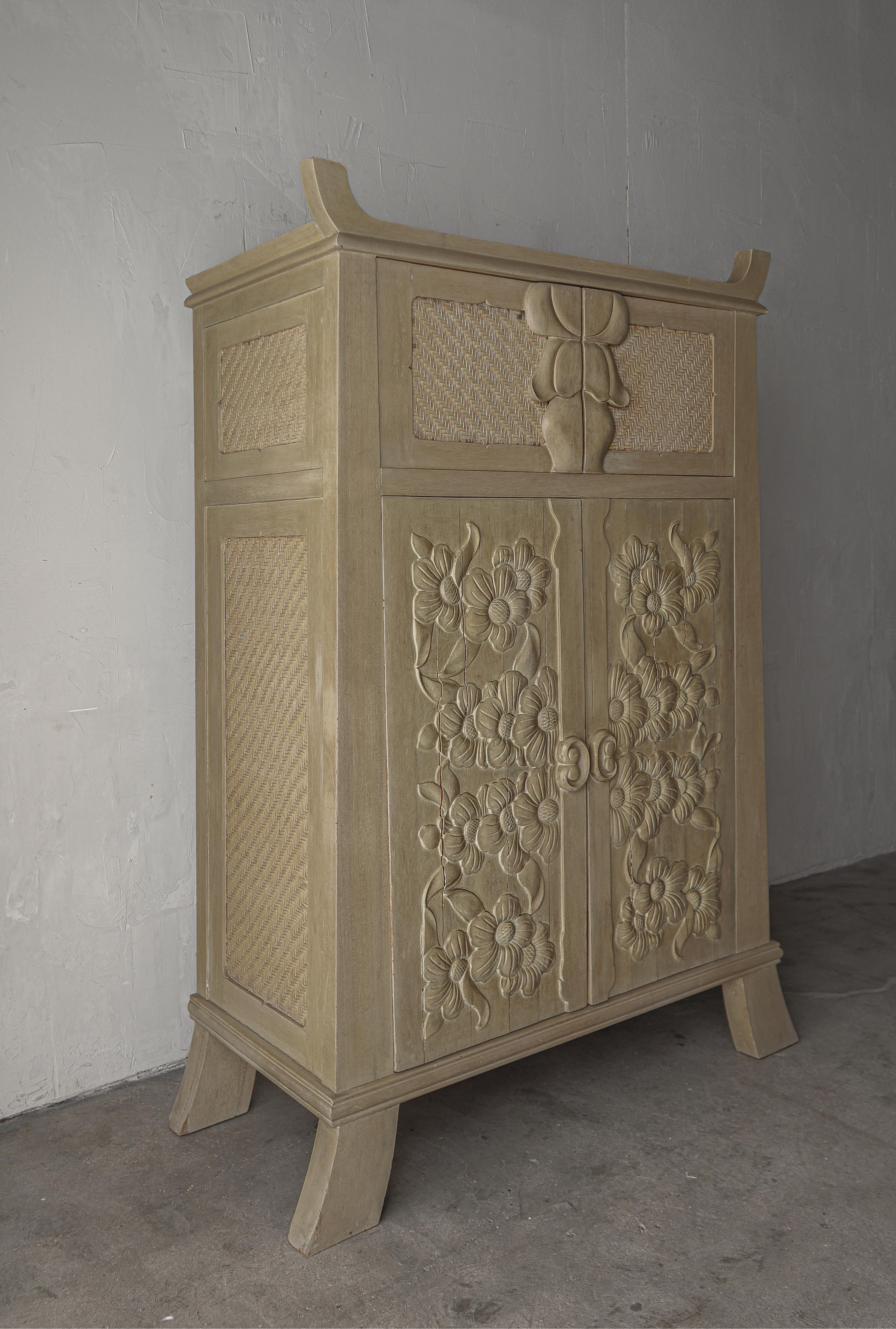 This vintage, hand carved wood relief cabinet is INCREDIBLE.  So unique I have been unable to find another example of any kind.  Everything from the beautifully carved floral motif to the woven leather panels.  A unique, intricate and gorgeous