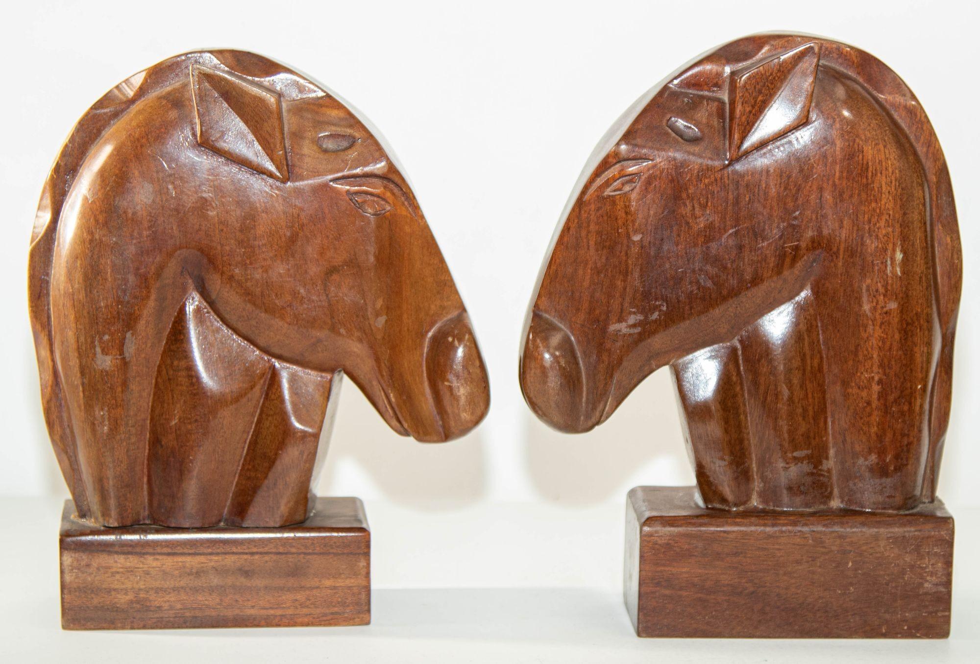 Vintage pair of hand carved wooden Art Deco style horse head bookends.
Large heavy wood vintage hand carved Art Deco style Folk Art horse bust book ends on a pedestal-type base.
Each measures approximately 9.5