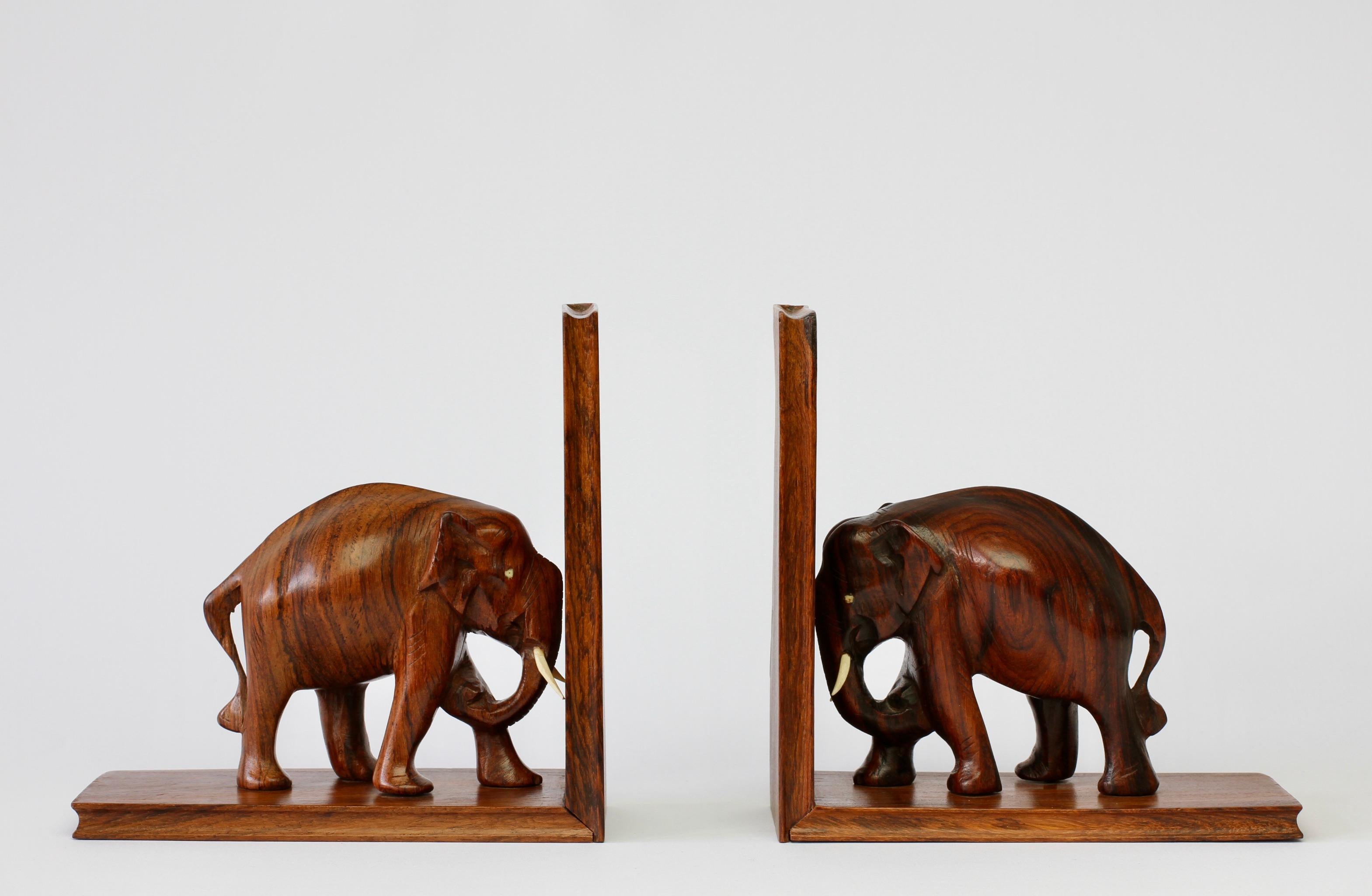 Vintage midcentury wooden bookends with carved elephant sculptures / carvings - probably Indian in origin and made, circa 1960s. Beautifully shaped and hand carved. These would also sit well within any Scandinavian or Mid-Century Modern inspired