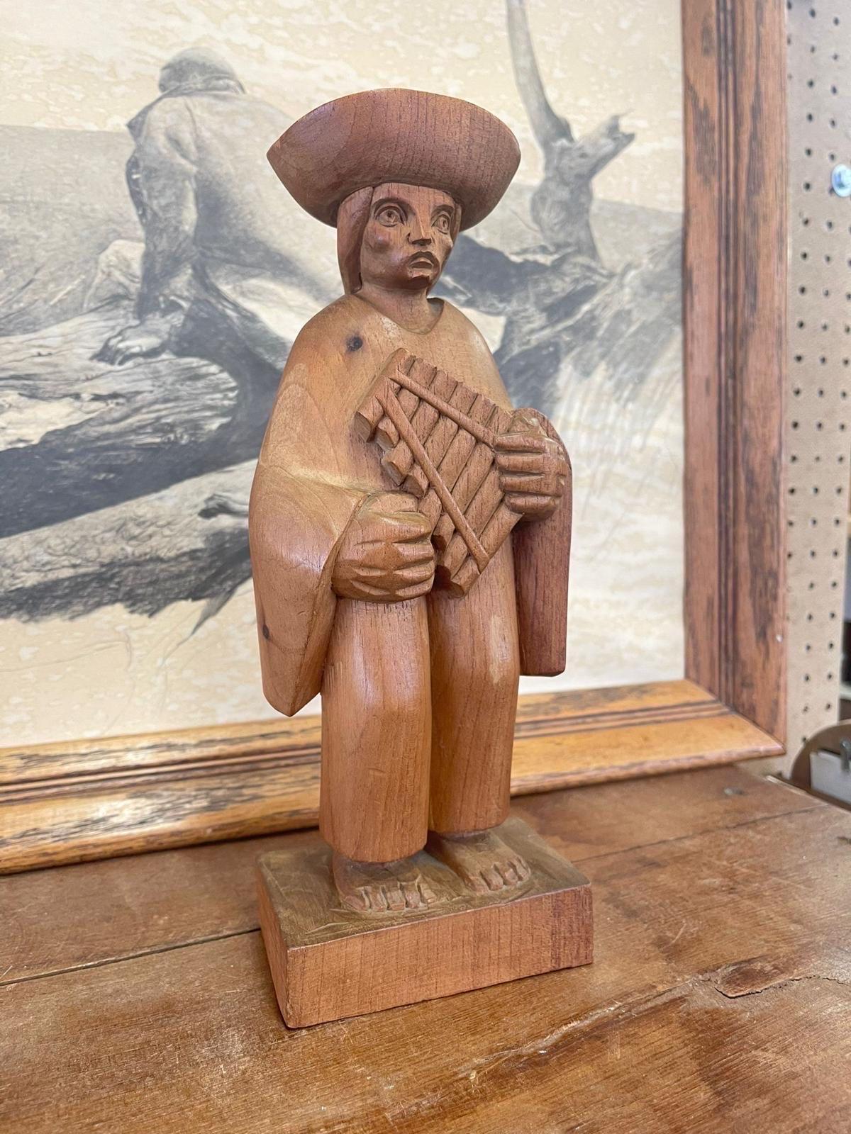 This wooden figure was hand made in Ecuador. Depicts a person carrying a flute. Beautiful wood grain with exaggerated features. Vintage Condition Consistent with Age as Pictured.

Dimensions. 5 W ; 3 D ; 12 H