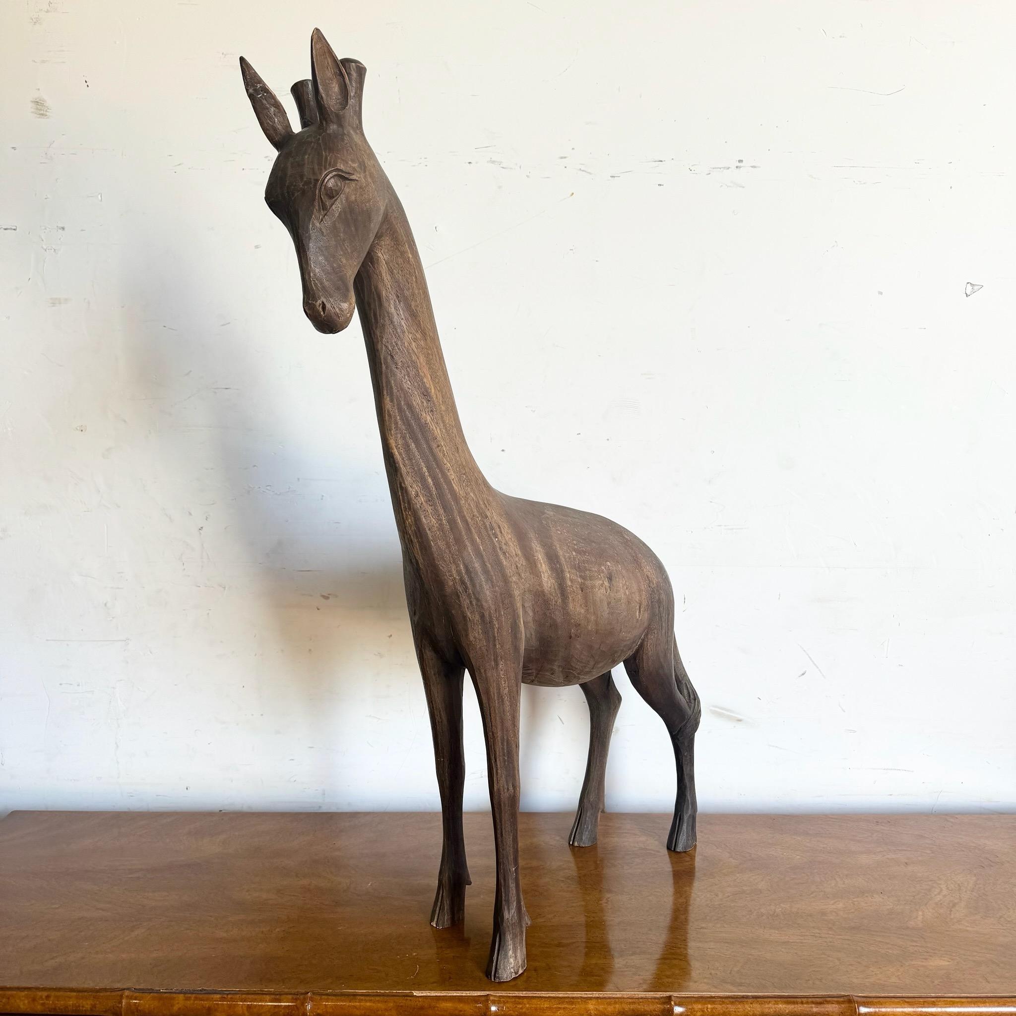Dai un tocco di bellezza naturale al tuo spazio con questa scultura vintage di giraffa intagliata a mano in legno. Realizzato con dettagli intricati, questo pezzo mette in mostra l'eleganza dell'arte africana e della fauna selvatica, rendendolo un