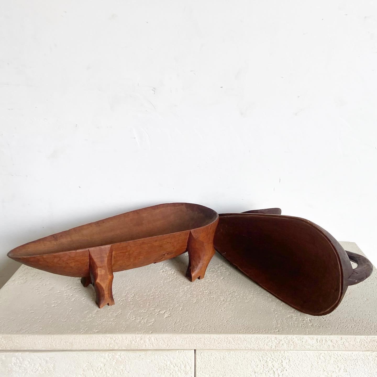 This Vintage Hand Carved Wooden Pig Container/Tray offers whimsical functionality. Crafted from solid wood, the removable top half reveals a shallow bowl for storage or serving, making it an interesting and practical addition to any setting.
Vintage