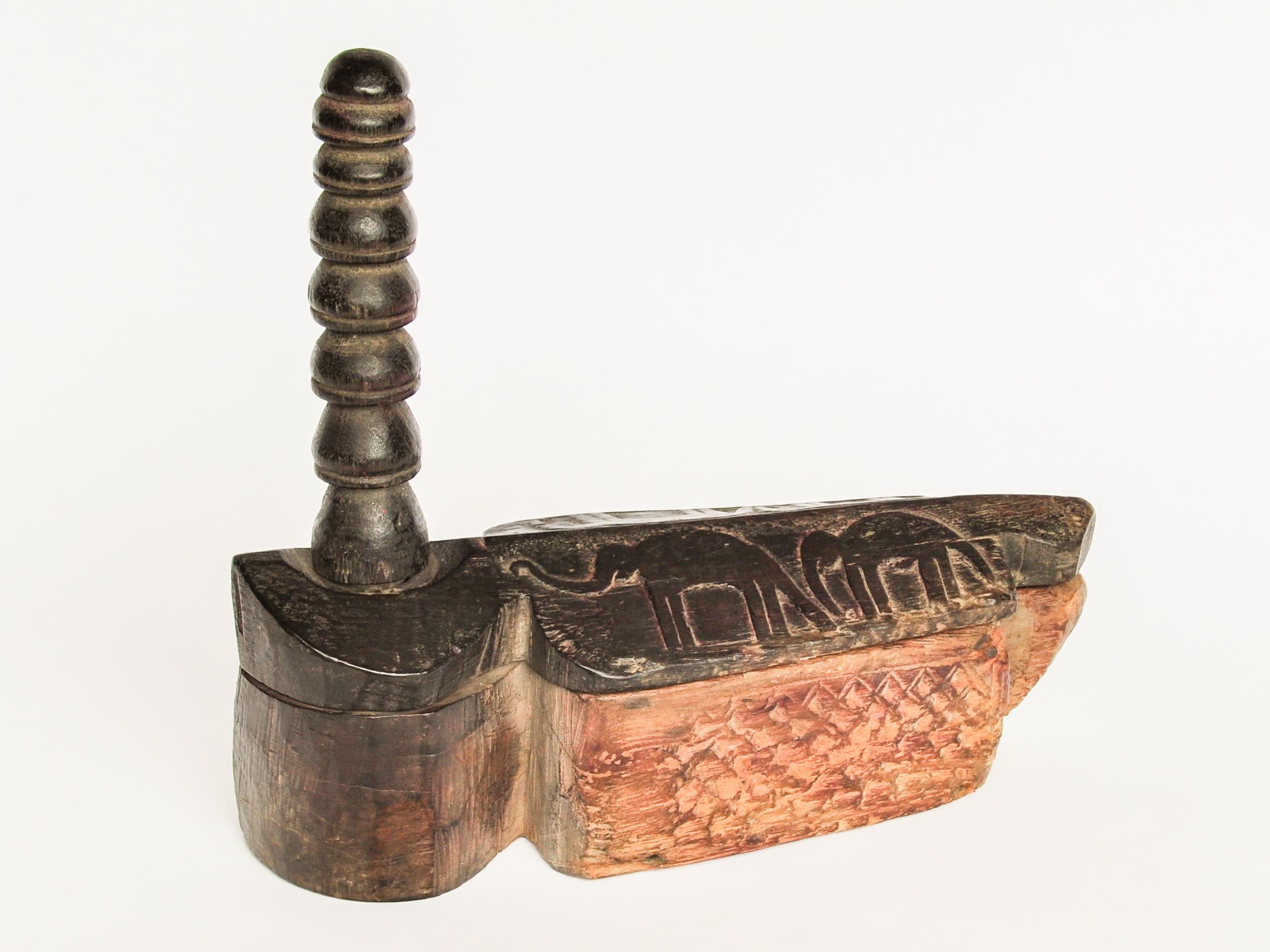 Hand-carved lidded wooden spice box with elephant motifs. From the Tharu of Nepal. Mid-20th century.
This charming spice box comes from the Tharu of southern Nepal. It is hand-carved of a dense local wood, with geometric patterns on the side, and