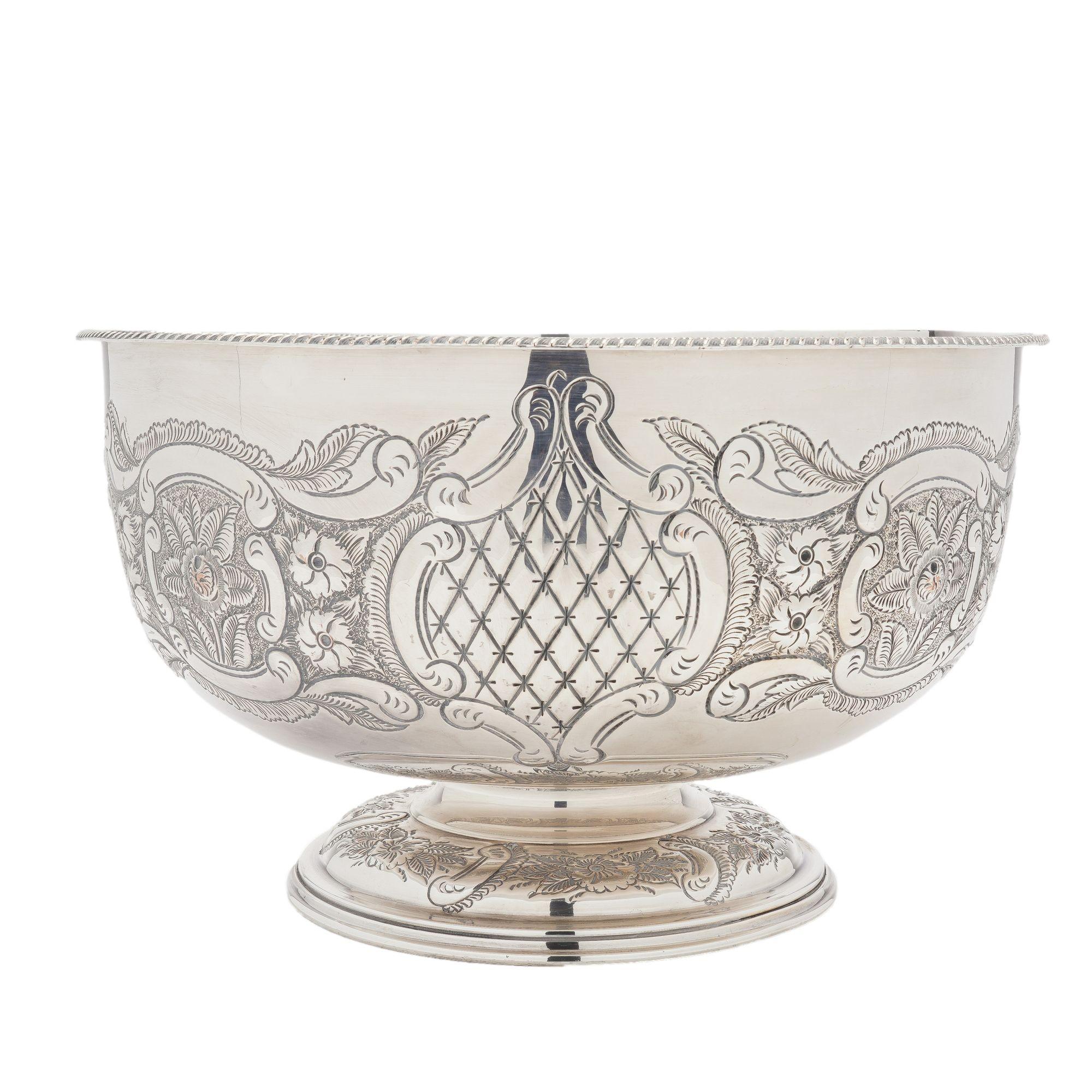 Vintage English Sheffield punch bowl & tray. The punch bowl is hand chased with repoussé images of a bounty of fruit and flowers and a cast gadroon edged rim. The domed foot of the bowl is chased with the same repoussé design featured on the body of