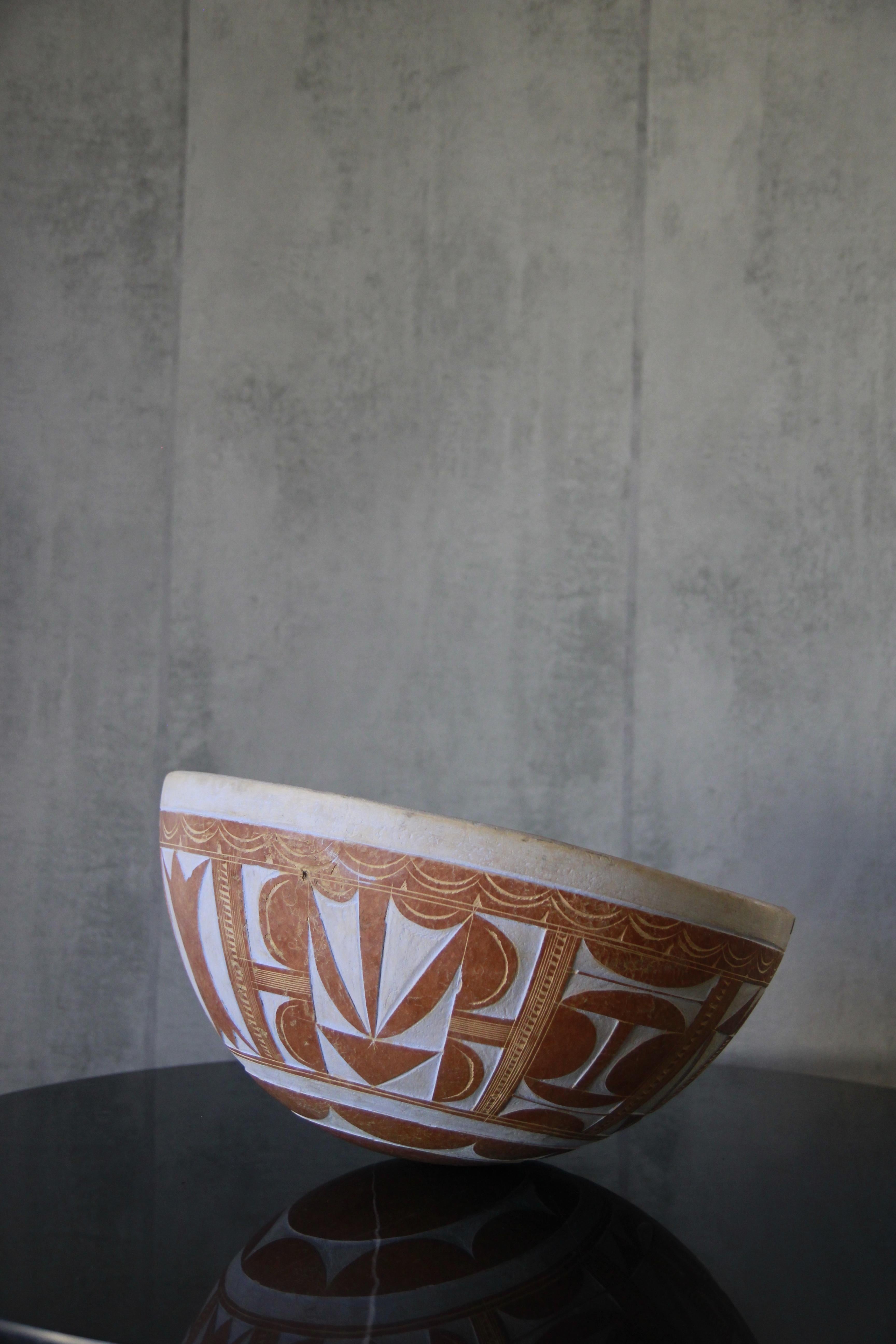 Hand-carved and beautifully crafted natural Calabash gourd bowl, made by artisans in West Africa with gorgeous tribal geometric pattern. The calabash gourd is hollowed out, dried and hand crafted. The bowl is extremely light. It can be use for