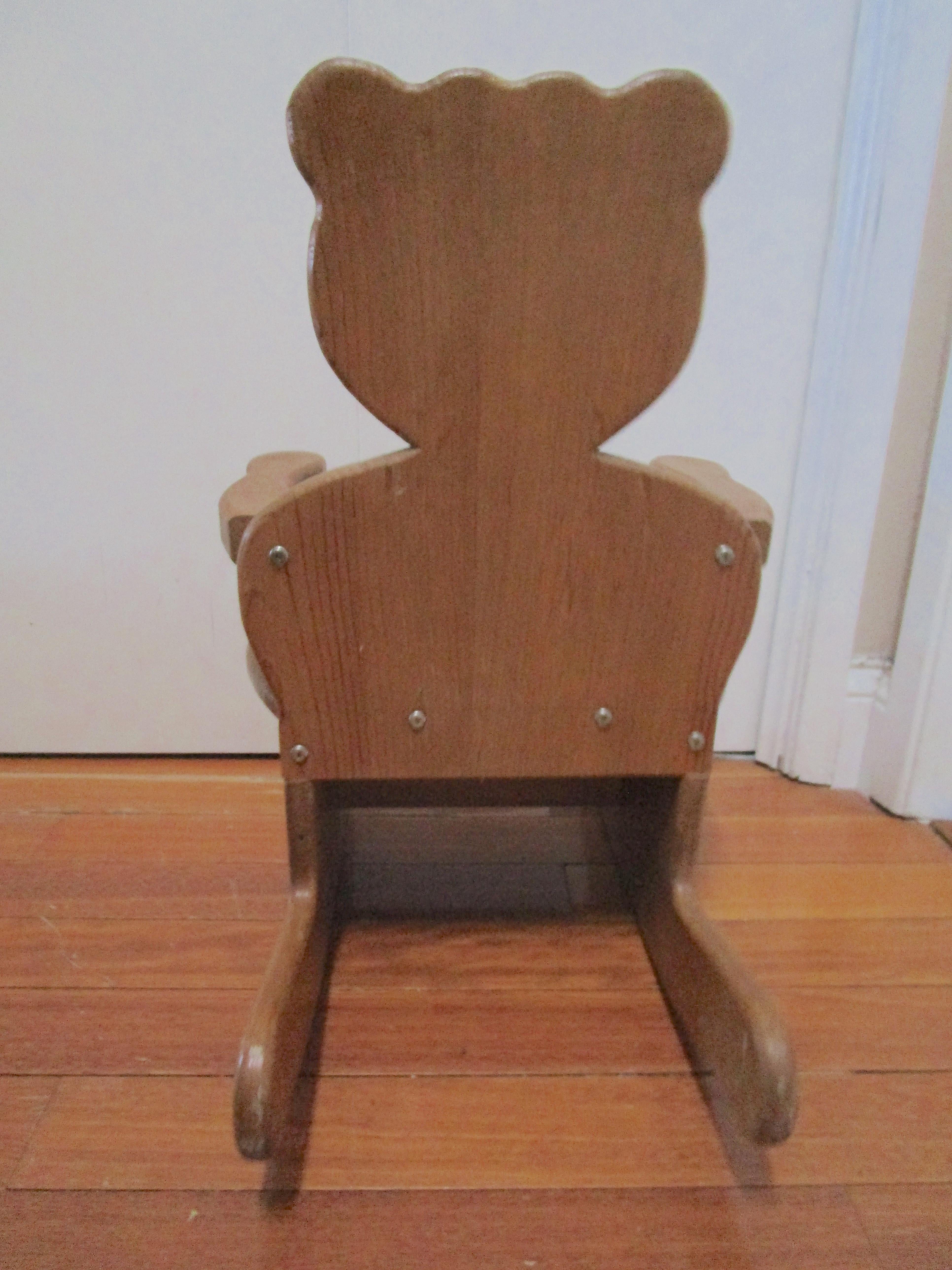 This charming teddy bear rocking chair in solid hardwood is perfect for the personal space of a little person. The chair has developed a nice patina and it is solid and tightly constructed. It is handcarved, handmade and in good condition with