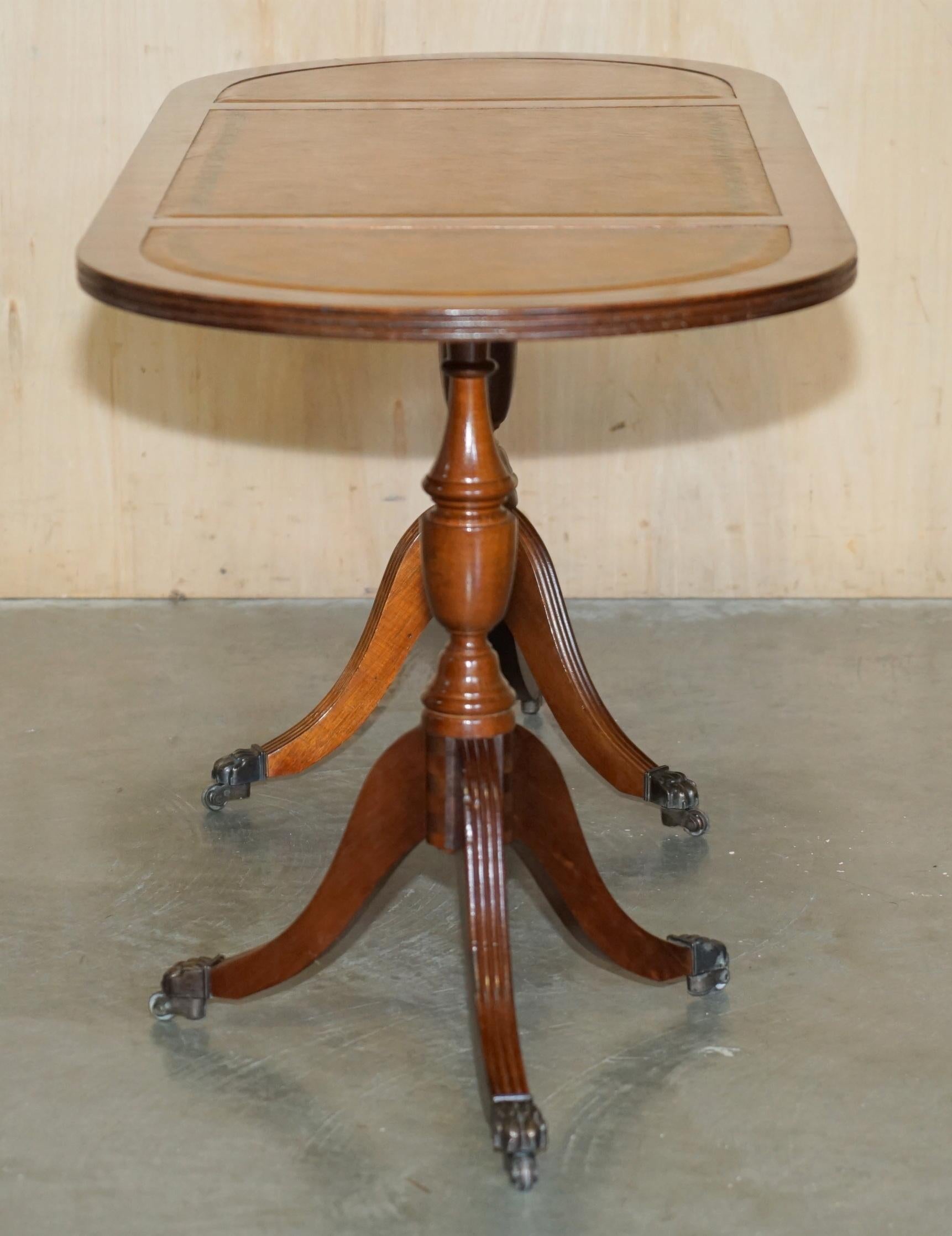 ViNTAGE HAND DYED AND AGED BROWN LEATHER OVAL COFFEE TABLE WITH LION CASTORS For Sale 13