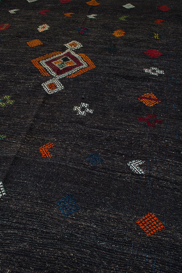 The beauty and artistry in our Kilims is revealed in the small details.
Take for example this Vintage piece that was created using natural un-dyed wool, mixed with goat hair and hand-embroidered with colorful symbols woven only by women as a way to