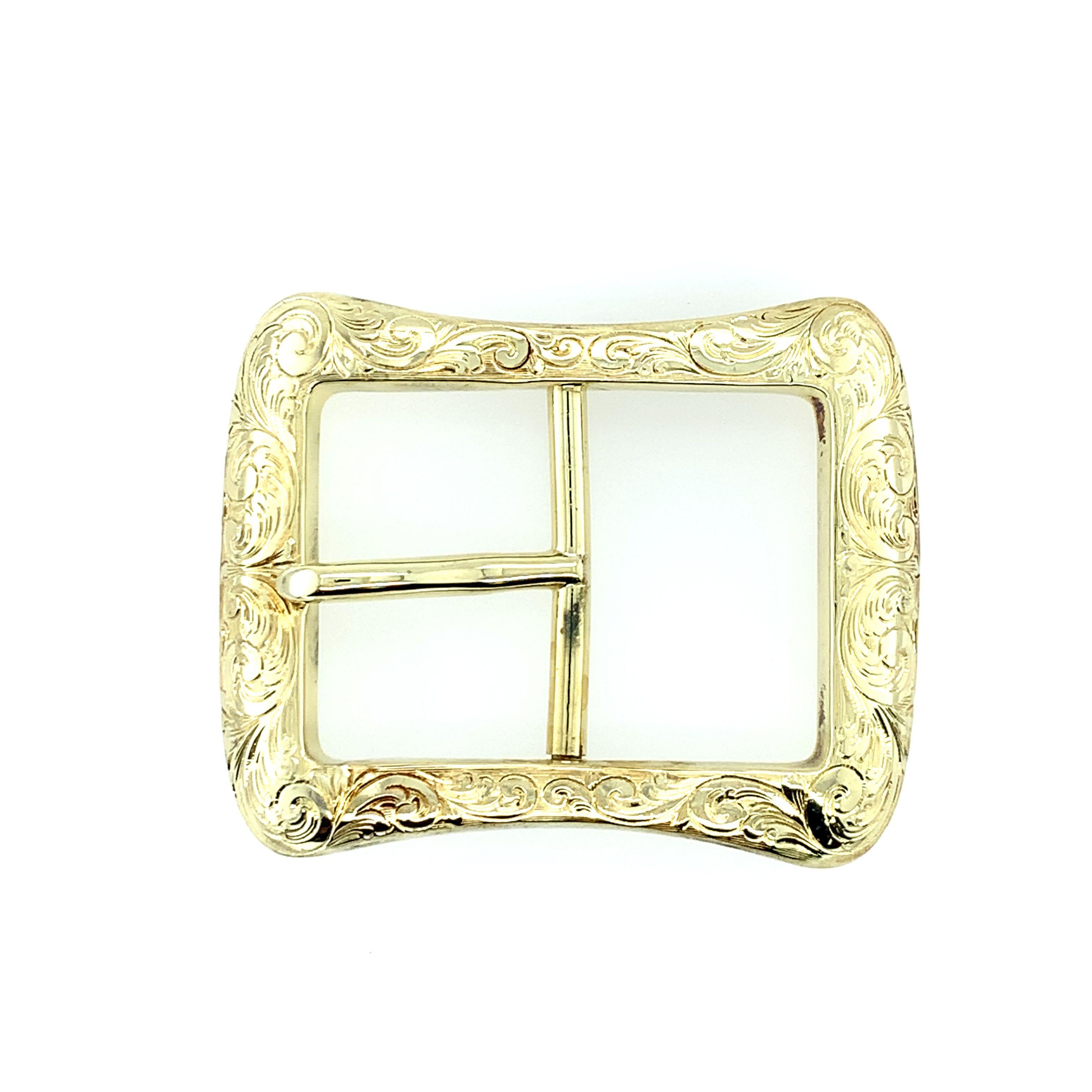 A heavy and solid rectangular-shaped belt buckle hand engraved from 14K yellow gold. Fine engraving details include a scroll pattern on the front while the back is high polished. The belt buckle measures 2
