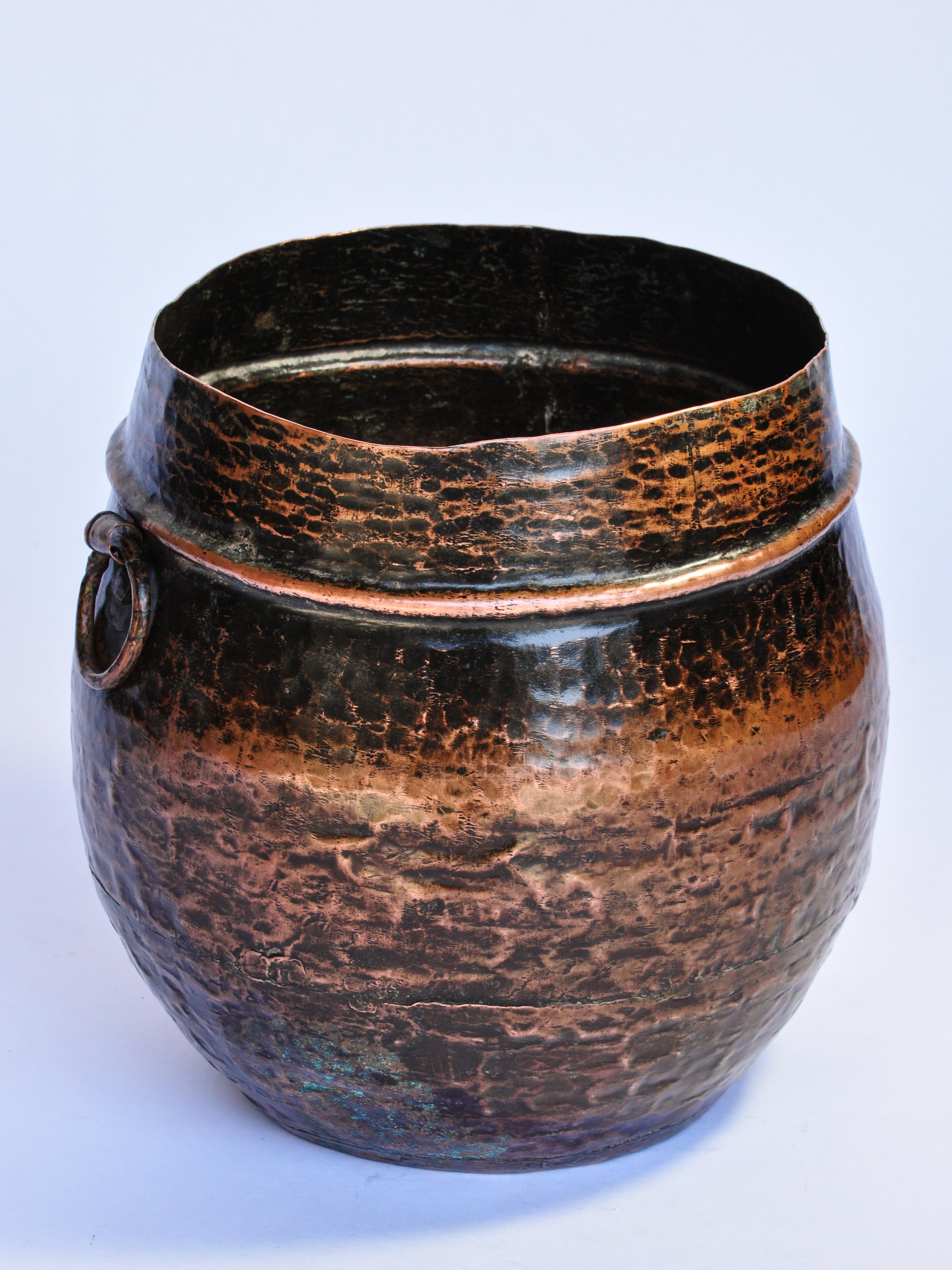 Vintage hand hammered copper measuring pot from Nepal, early to mid-20th century
This handcrafted rustic copper pot is called a Pathi, a standard unit of measure for grains and lentils. It would have been used in a market setting, as they still are