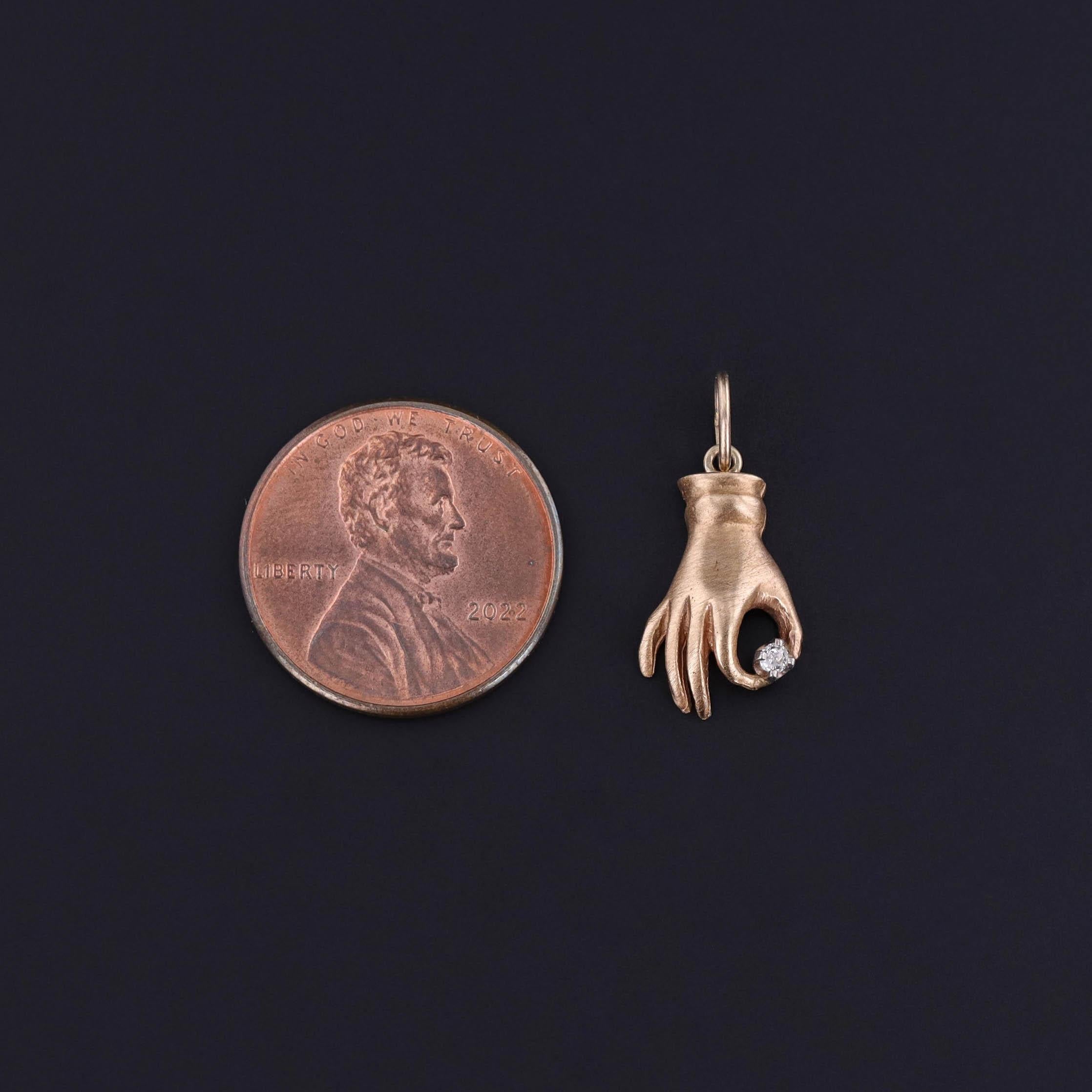 1940s 12k Gold Hand Charm Holding a Diamond

A striking symbol of grace and strength, this antique charm from the 1940s features a finely detailed hand sculpted in solid 12k gold, gently cradling a sparkling diamond at its fingertips. Meticulously