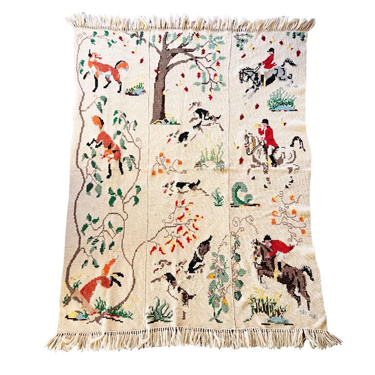 A hand-knitted English hunting scene motif afghan. This will be a great bed cover or throw blanket! The overall throw is crocheted with a creamy almost khaki yarn. The scenes are separated into three panels. The first, (on the left column) are brown