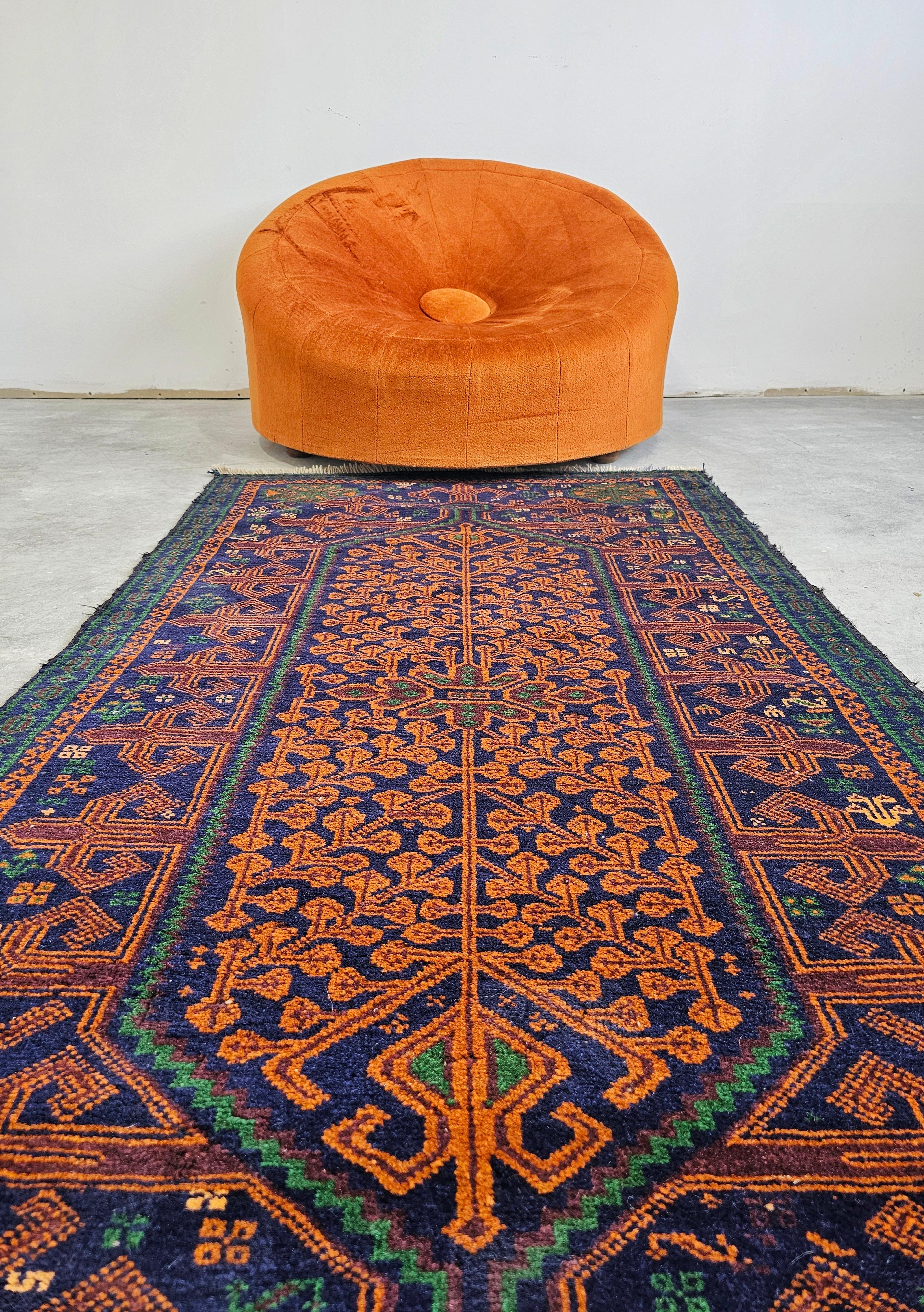 In this listing you will find a highly decorative vintage Baluch rug with great combination of colors - navy, green and gold. This Persian rug was hand-knotted in Afghanistan in the 1960s. The armchair visible in the pictures is not included.

Very