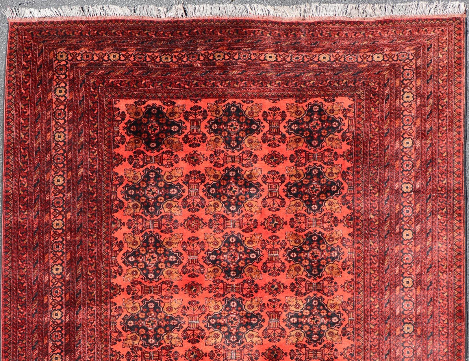 East Turkestani Vintage Hand Knotted Tukomen Ersari Rug in Red Background With Gul Design For Sale