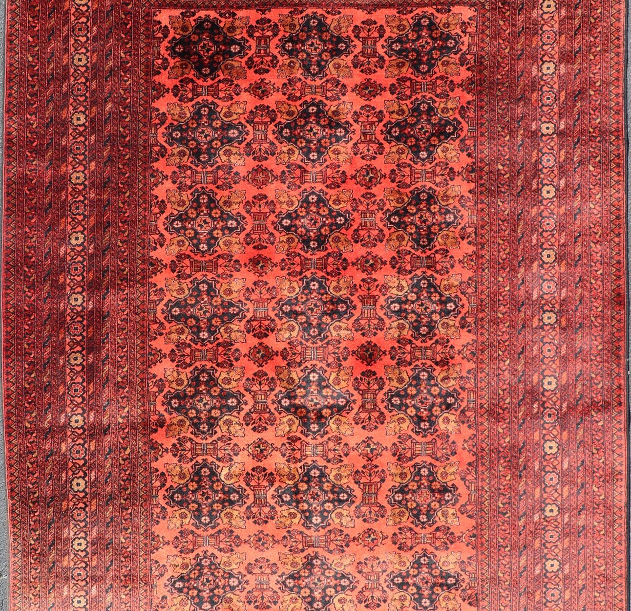 Hand-Knotted Vintage Hand Knotted Tukomen Ersari Rug in Red Background With Gul Design For Sale