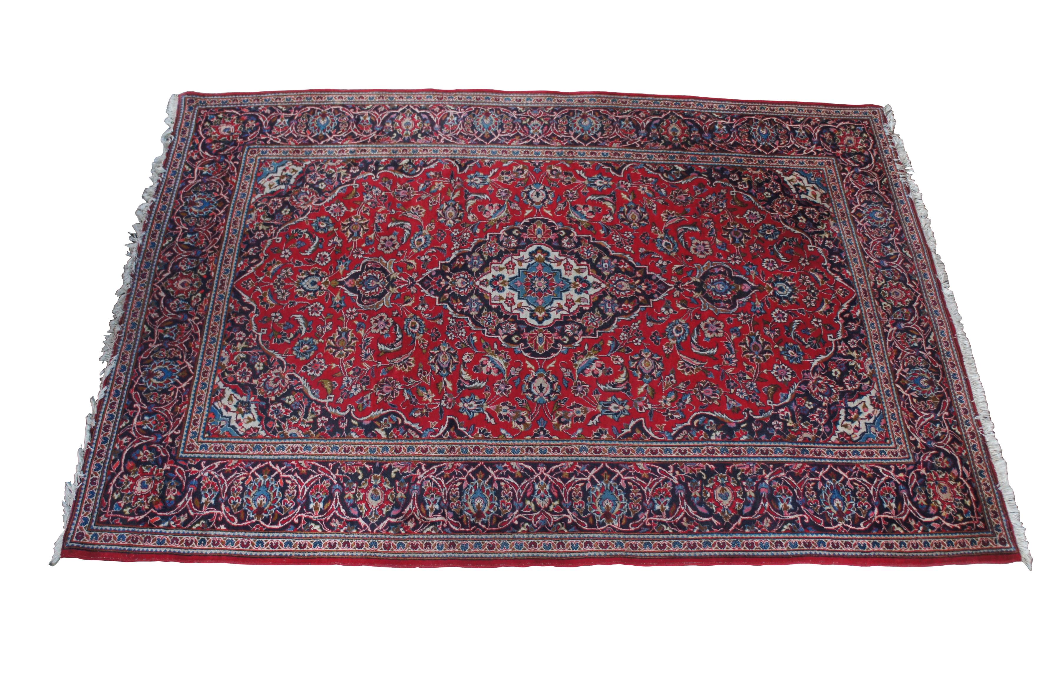 A beautiful red and blue hand knotted Persian Kashan Hand-Knotted wool area rug from the last halfof the 20th century.  Features beautiful floral and geometric detail. 

There are few carpet provenances whose reputation can compete with that of