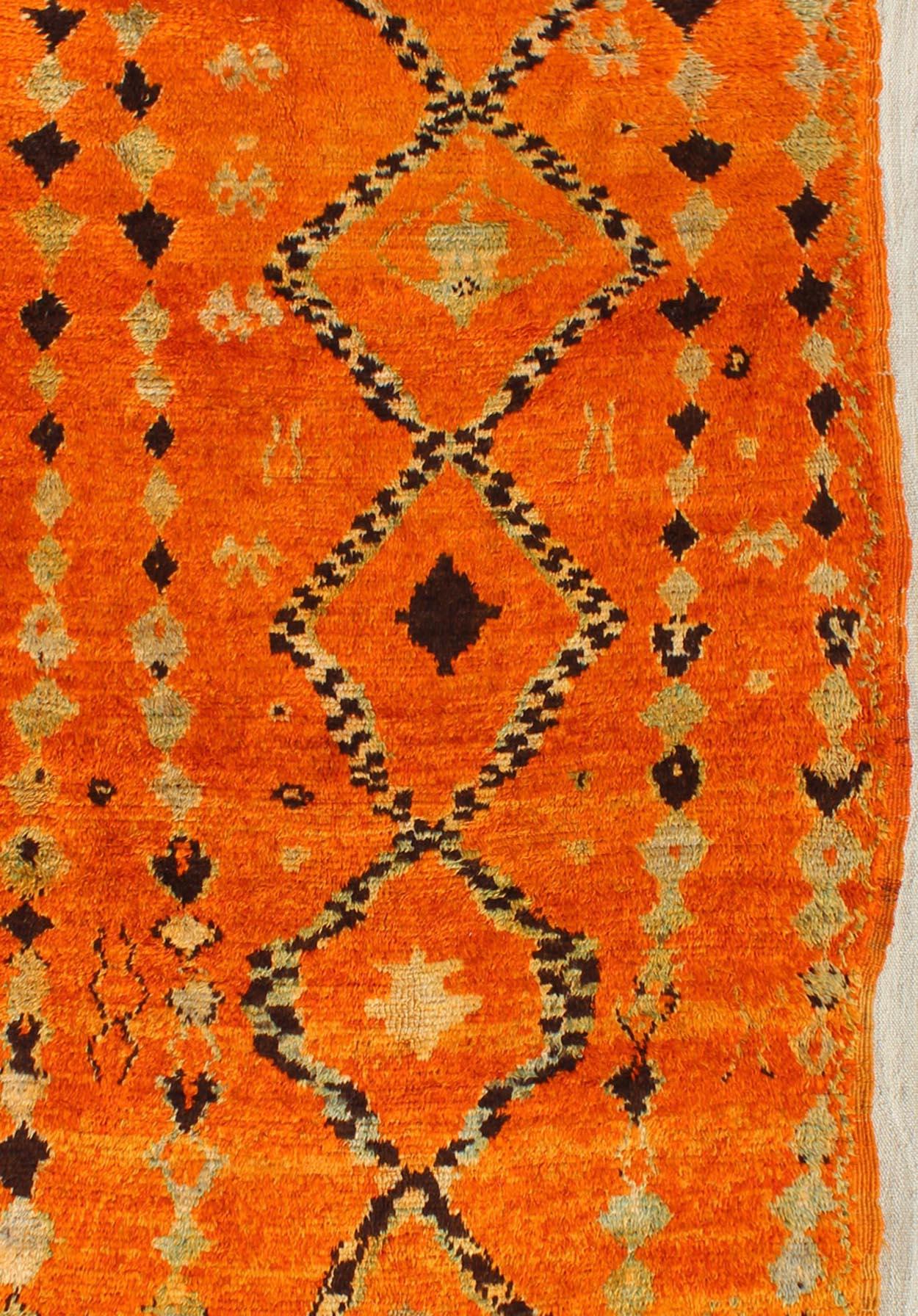 Tribal design vintage Moroccan rug in red, orange, charcoal, ivory, rug BDS-2100, Keivan Woven Arts / country of origin / type: Morocco / Tribal, circa 1940.

Vintage Moroccan Beni Mkild carpets are rarities from various regions of Morocco. From