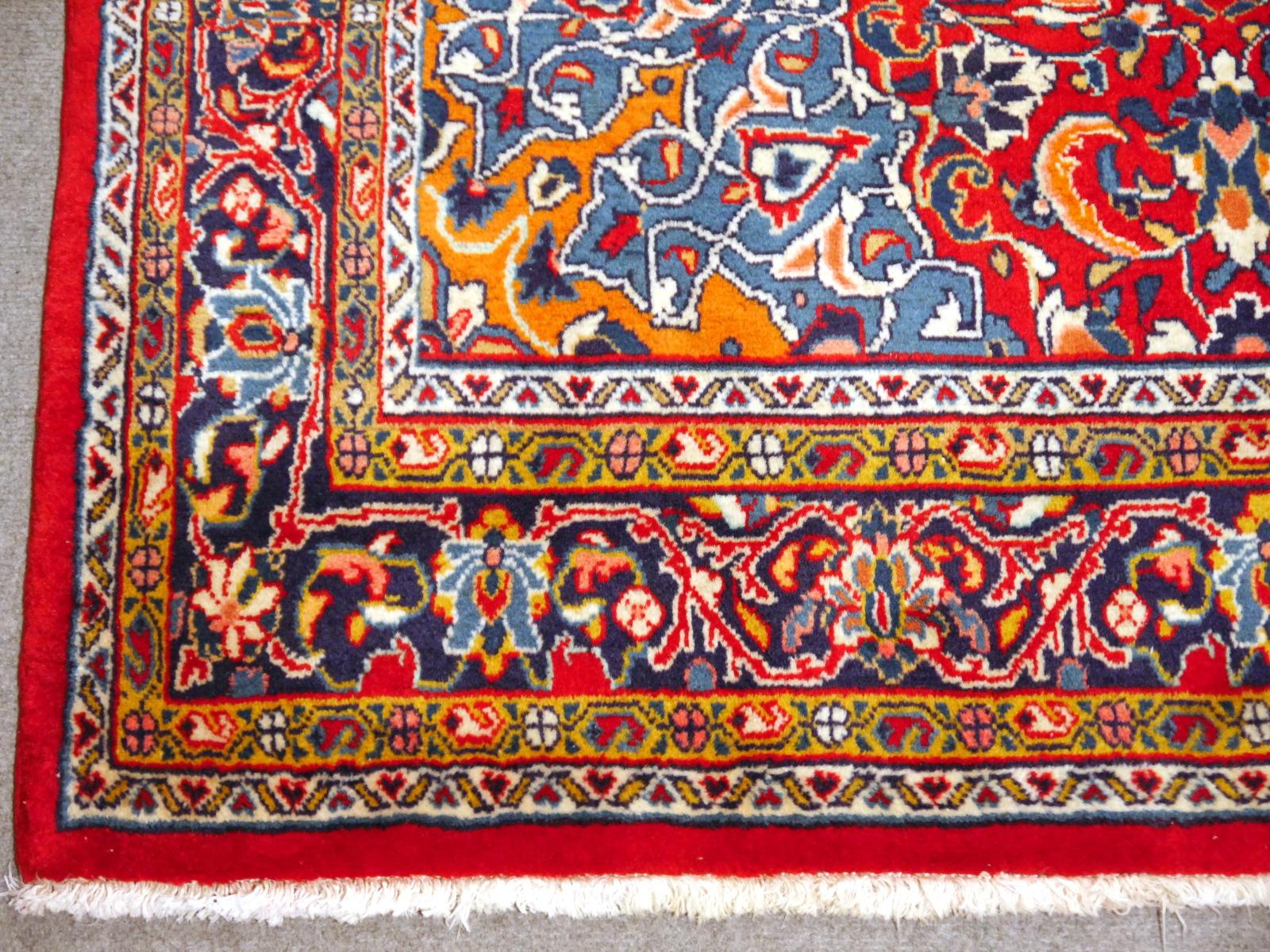 A hand-knotted Oriental rug in red and blue, made in the 1970s. Pile is pure wool, warp and weft is cotton. The rug is in very good condition with vibrant colors.