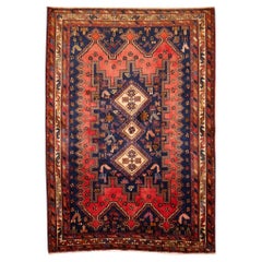 Tapis oriental vintage noué à la main à motifs tribaux rouges et bleus