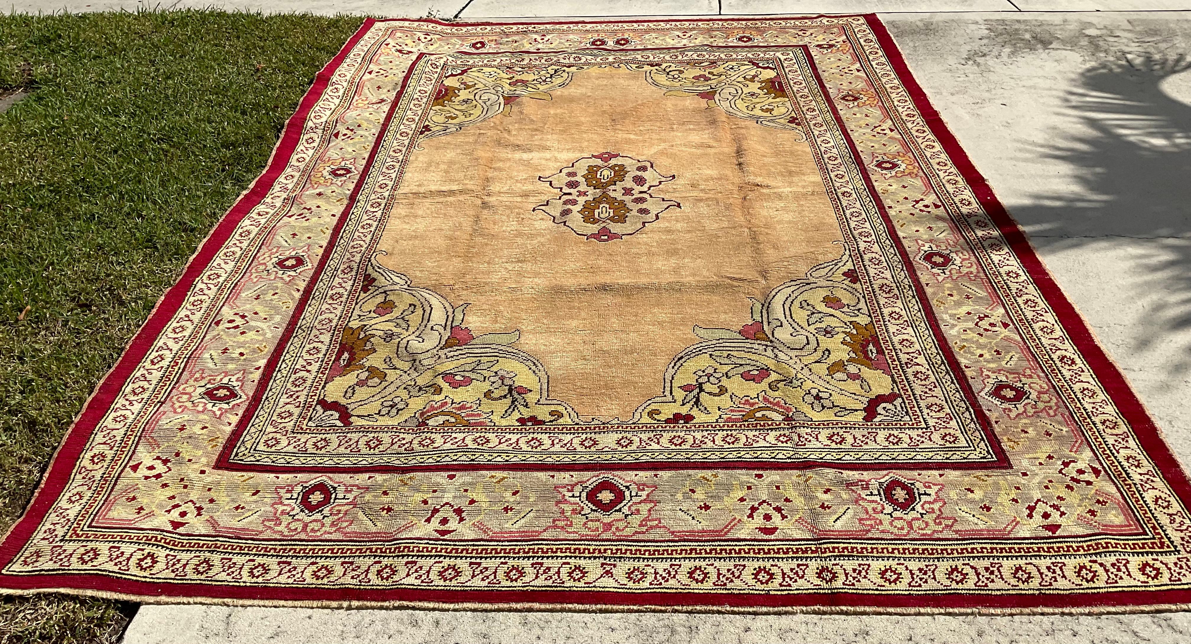 Beautiful hand-knotted wool rug with small center medallion exceptional intricate Geometric -floral borders , muted colors of salmon, yellow, pink and fuchsia, and thin vibrant of wine color border. 
One of a kind of tribal object of art.
     