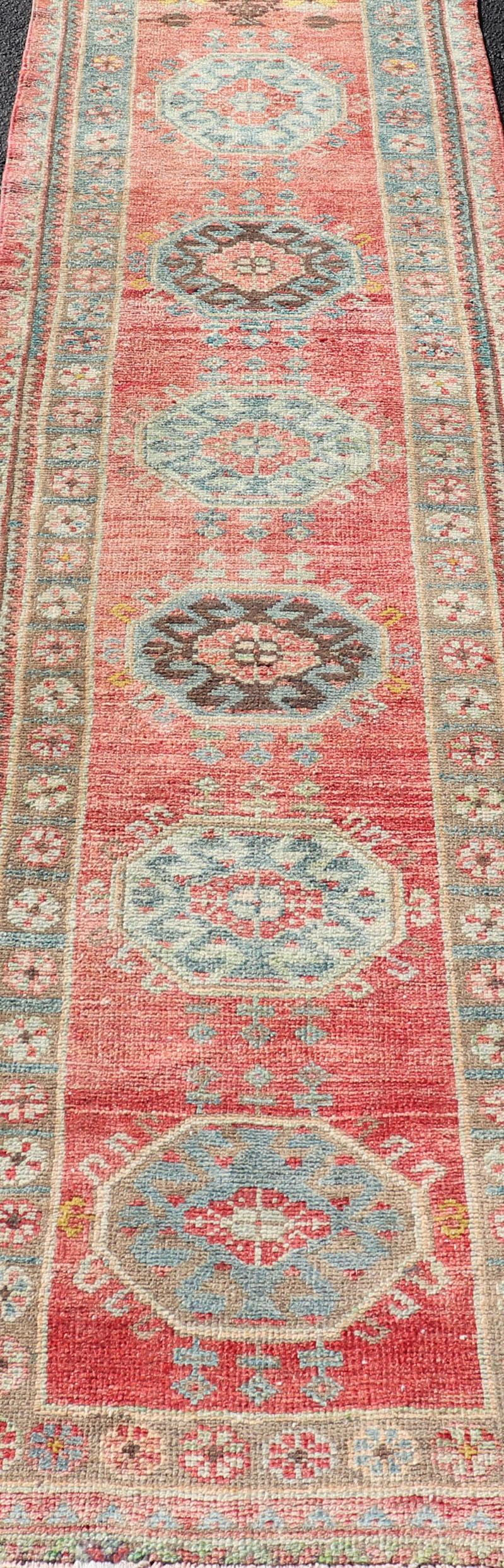 Wool Vintage Hand Knotted Oushak Turkish Runner with Geometric Medallion Design For Sale