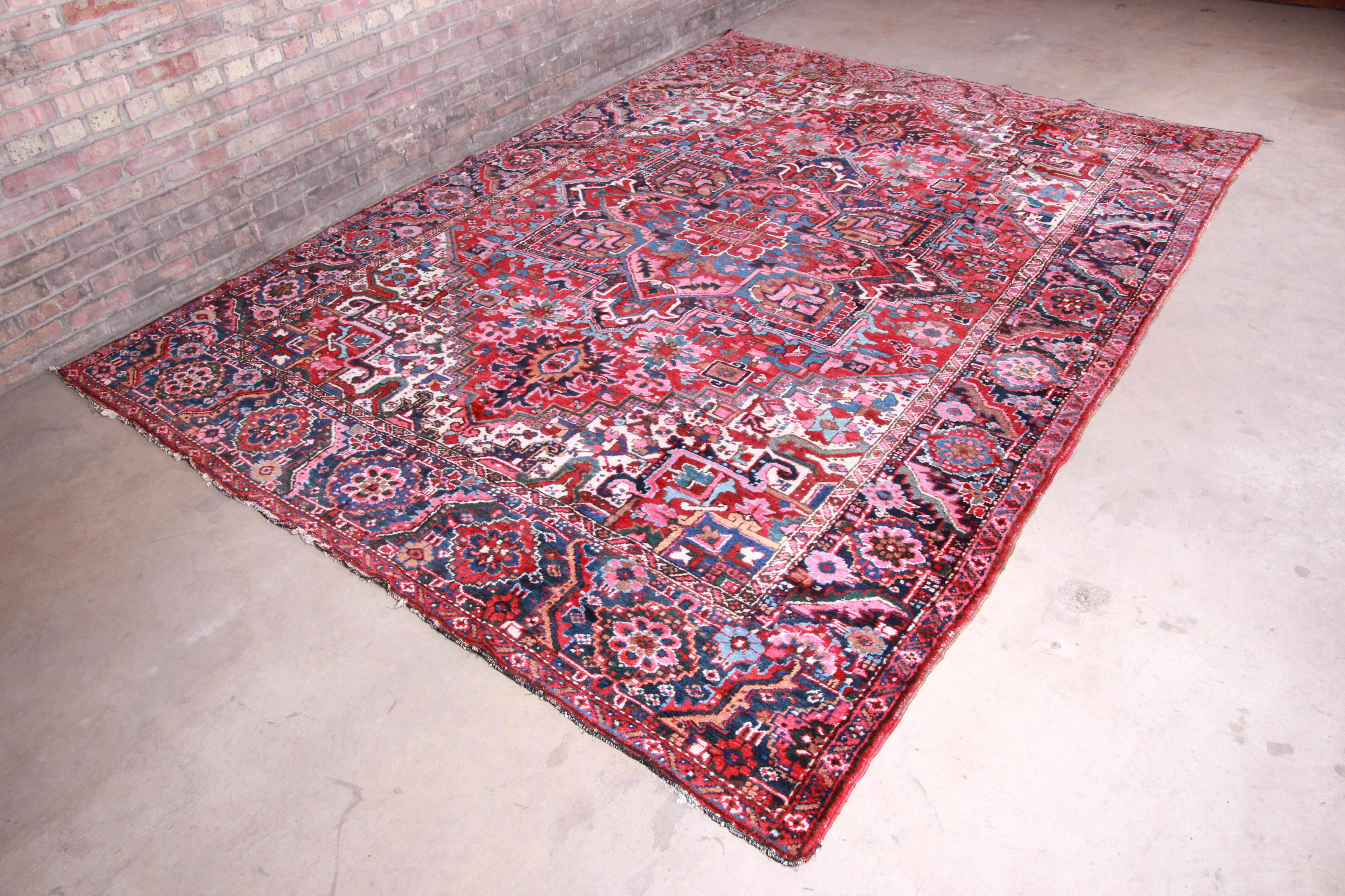 A gorgeous antique hand knotted Persian Heriz rug

circa 1940s

Classic geometric floral design, with vibrant colors.

Measures: 7