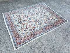 Vintage hand-knotted Persian rug done in natural white wool with floral pattern