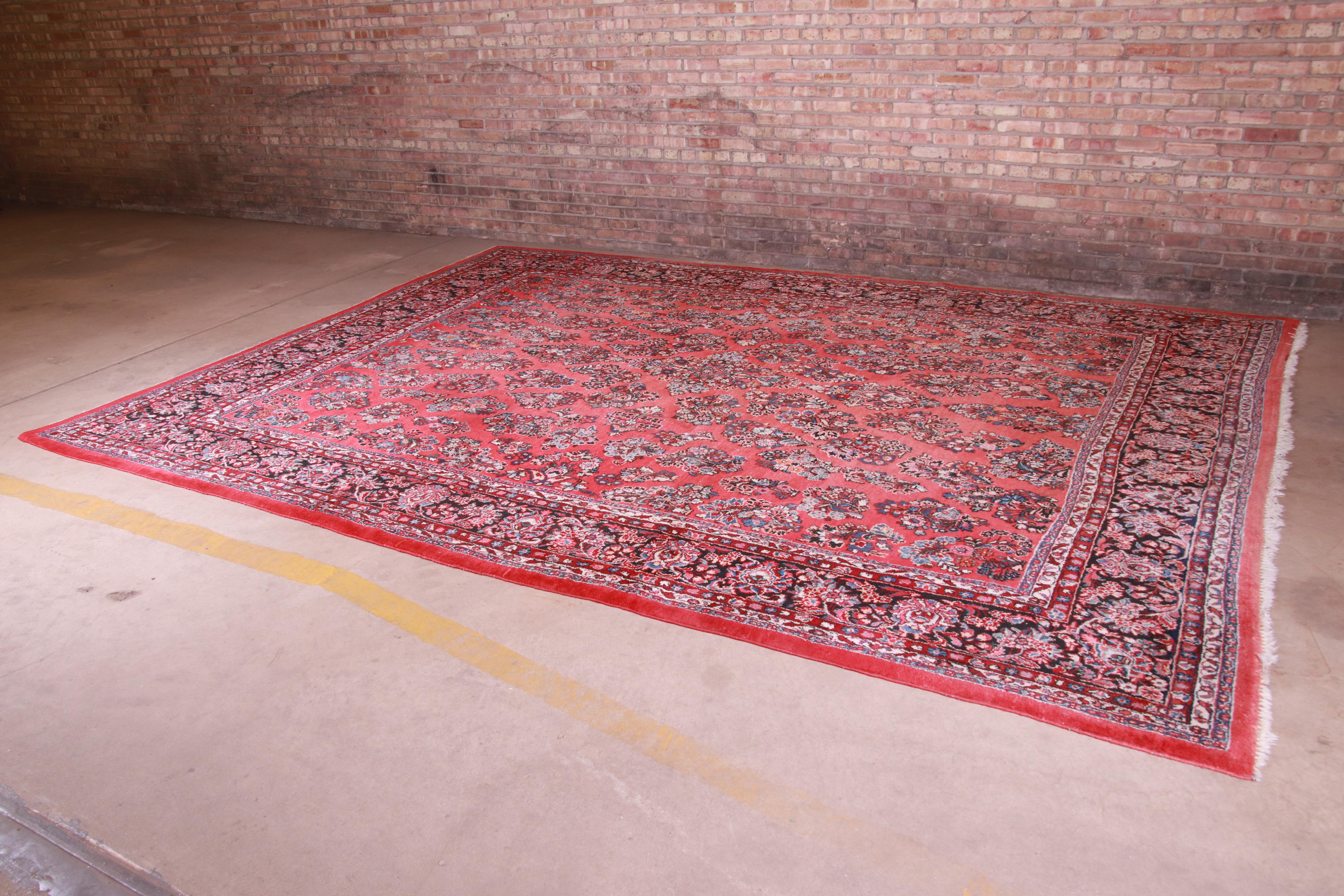 A gorgeous vintage hand-knotted Persian Sarouk room size rug

Persia, Mid-20th Century

Classic design with floral sprays and bouquets

Measures: 10