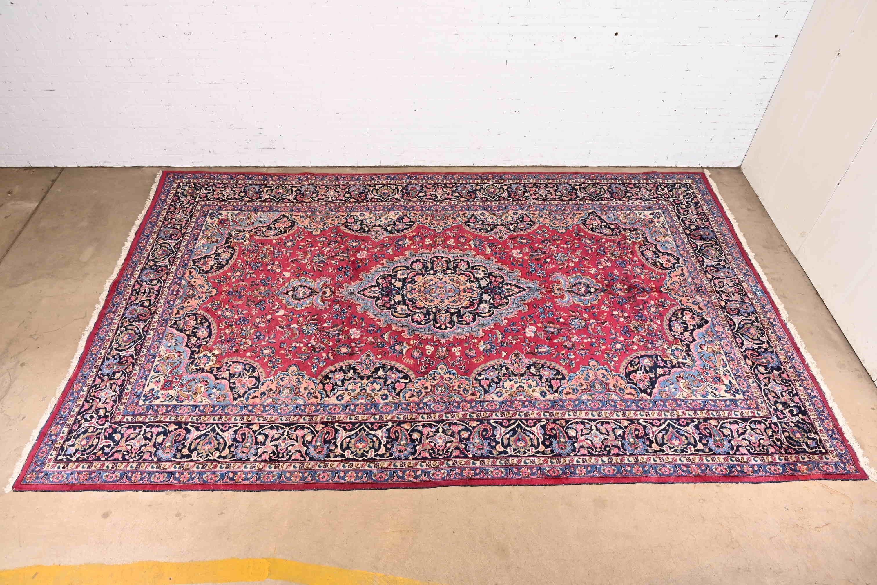 A gorgeous vintage hand-knotted Persian Tabriz large room size wool rug

Circa Mid-20th Century

Beautiful floral design, with predominant colors in red, pink, blue, and ivory.

Measures: 10' x 16'1