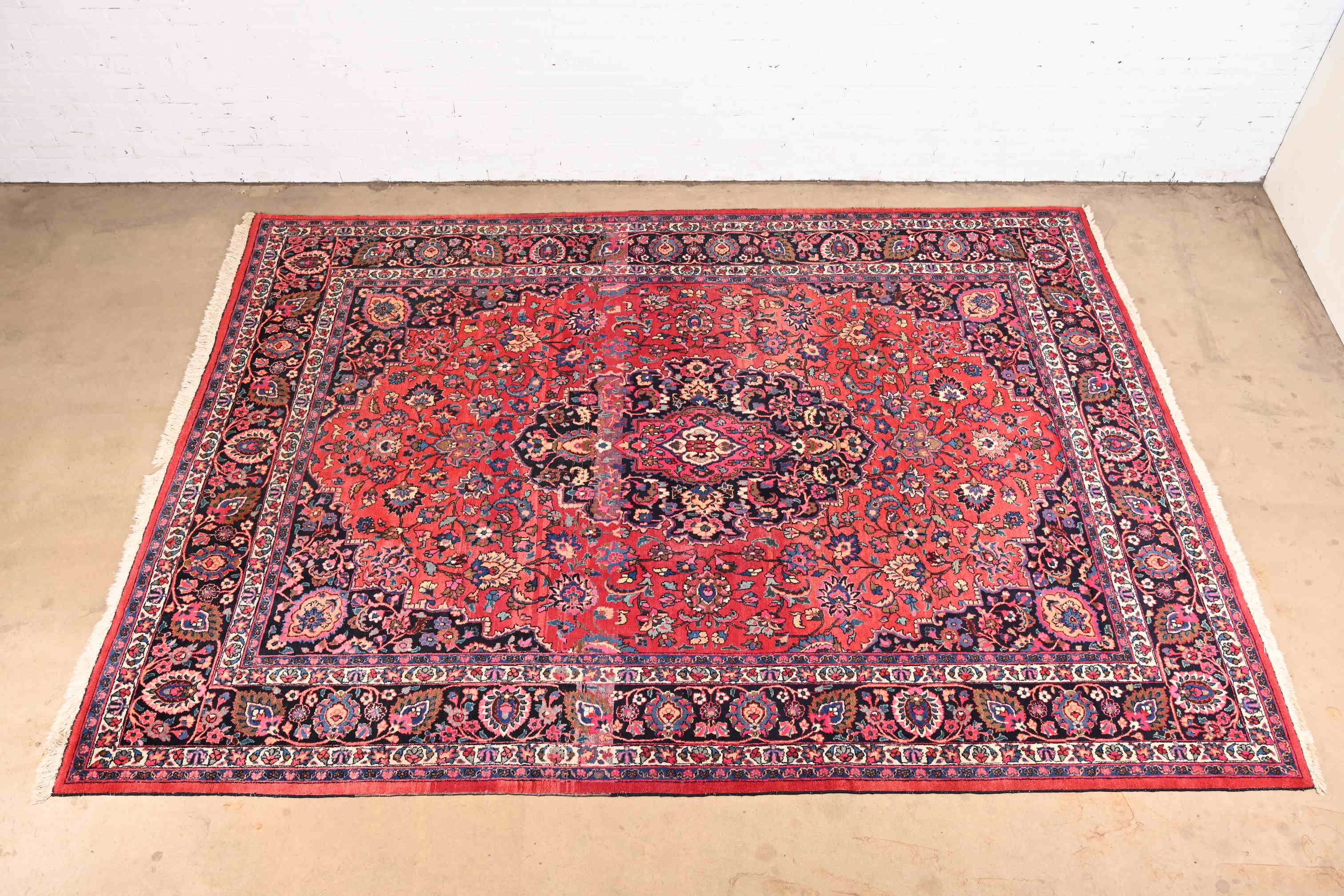 A gorgeous and vibrant vintage hand knotted Persian Tabriz room Size wool rug

Mid-20th century

Classic traditional floral design, with predominant colors in red, blue, pink, and ivory.

Measures: 8'7