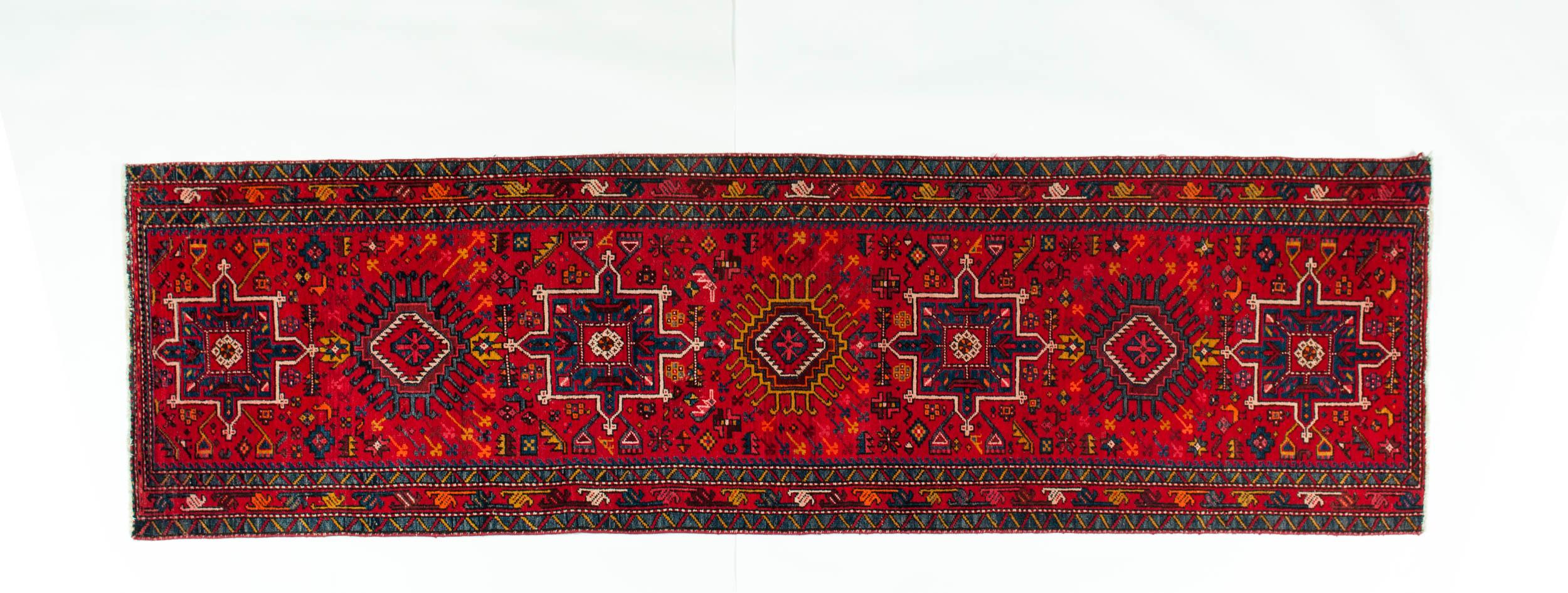 Vintage hand knotted Persian wool hallway runner / area rug. The runner is in great vintage condition and very clean. Minor wear consistent with age / use. The rug measure about 36 inches wide X 124 inches long .