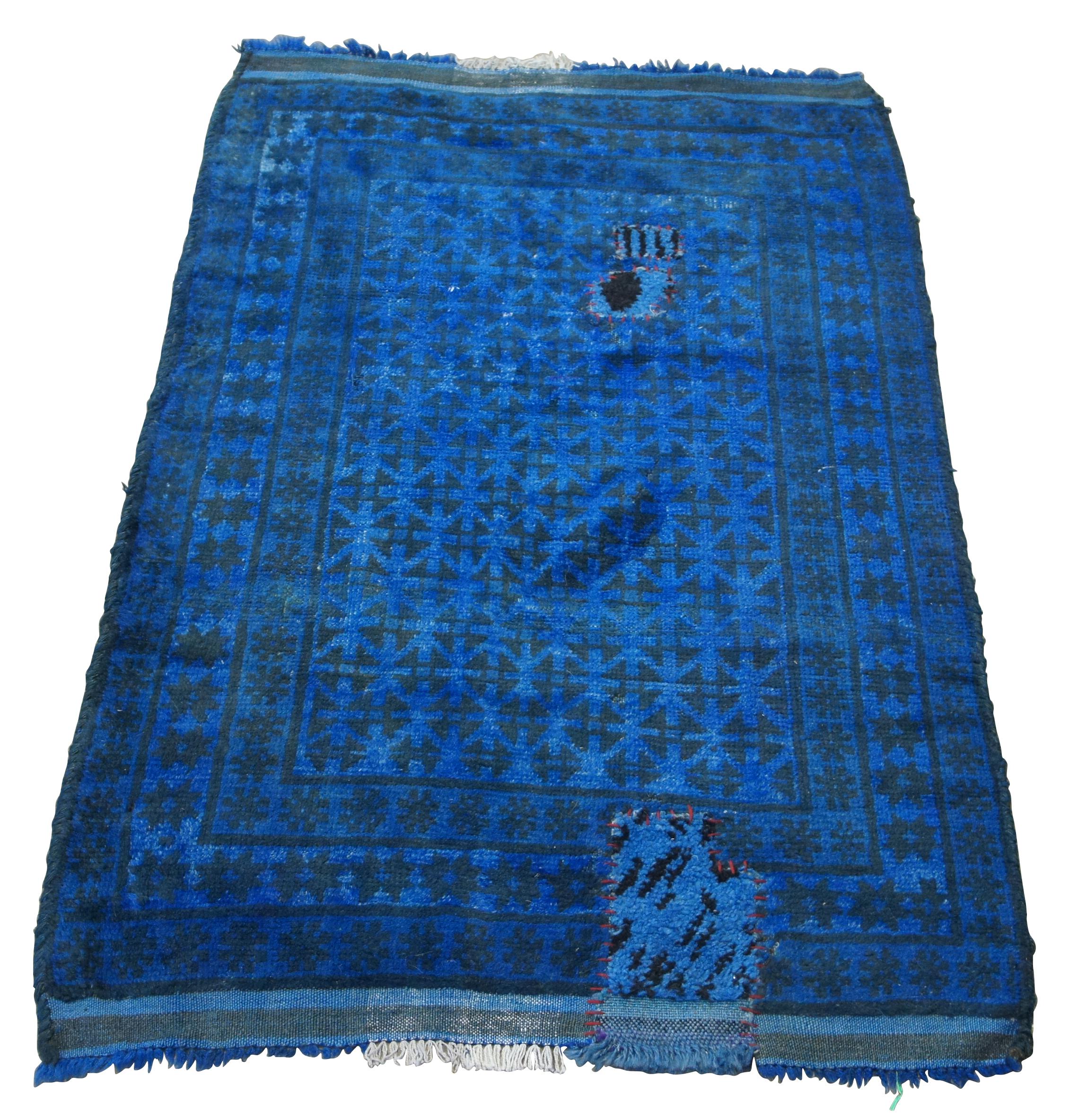 A lovely hand knotted Pakistani Balouch wool prayer rug, circa 1980s. Features a blue and black geometric pattern.

The area of Balochistan, the home of the Baluch rug (also Belouch, Balouch or Balooch), borders the south-east of Kerman on the