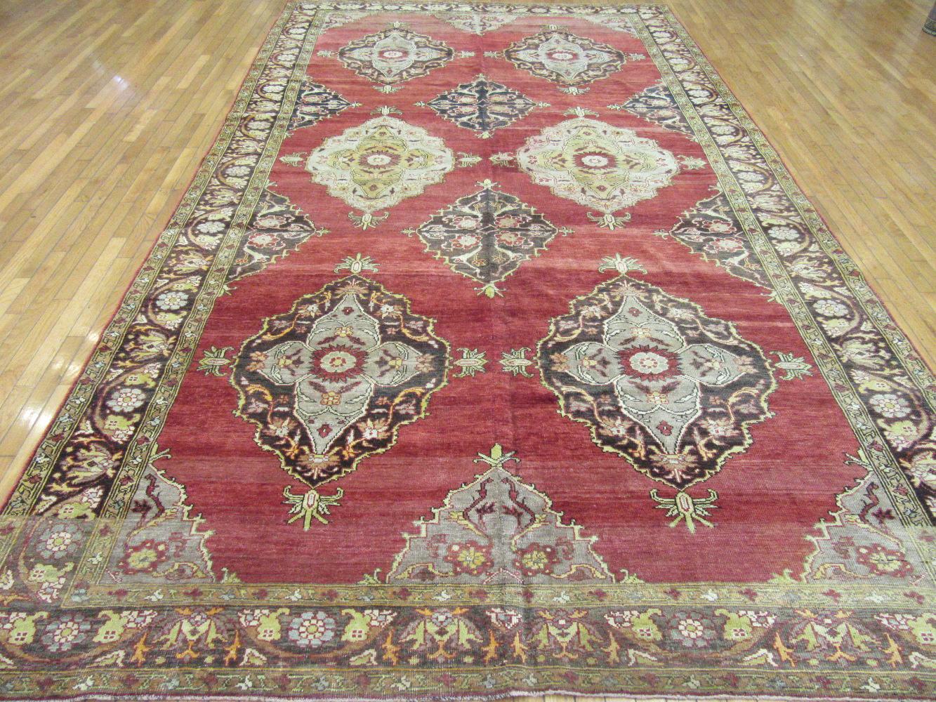 This is a hand-knotted vintage Anatolian Oushak rug from Turkey. It is made with durable Turkish wool and natural dyes. The rug has a flexible all-over pattern to be used almost anywhere in your home or office. It measures 7' 10'' x 13' 8''.
