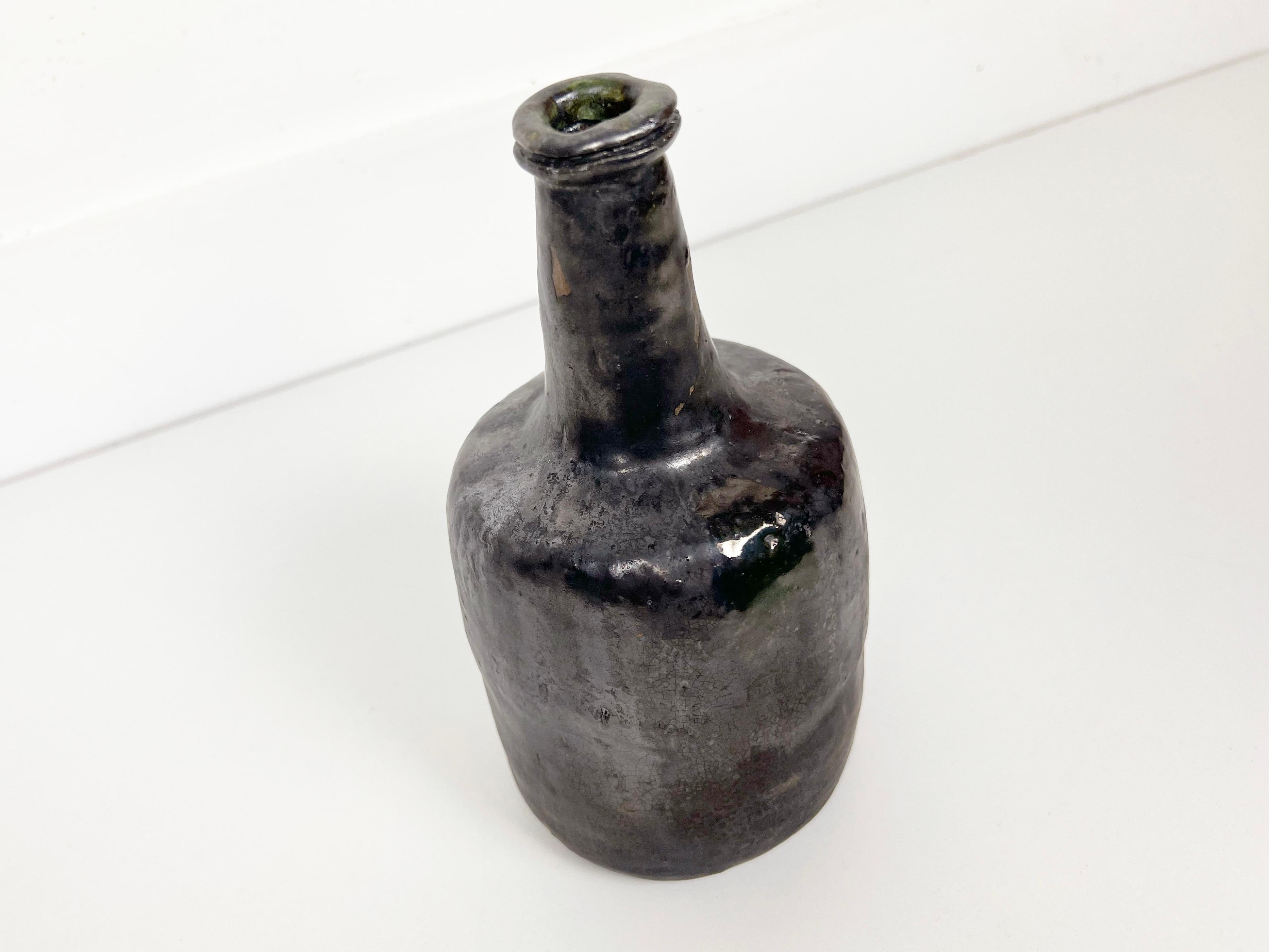 Vintage hand made crude ceramic bottle with black glaze. Signed 'DWO 1961'.

Artist: DWO

Year: 1961

Style: Mid-Century Modern

Dimensions: 9