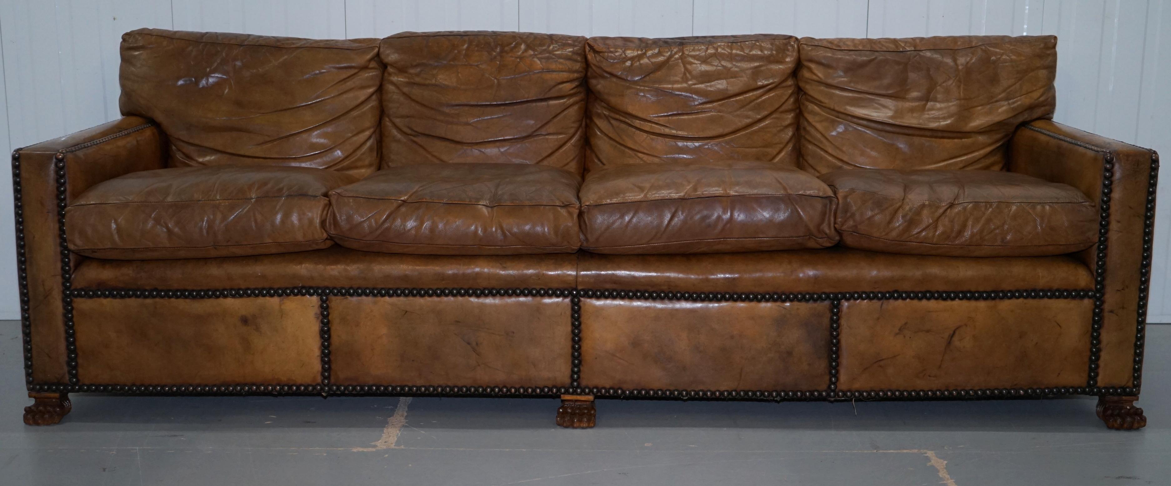 We are delighted to offer for sale this stunning aged tan brown leather Gentleman’s four-seat club sofa finished with lion hairy paw feet and with a great history

This piece is part of a suite, and with the original leather finish. 

These