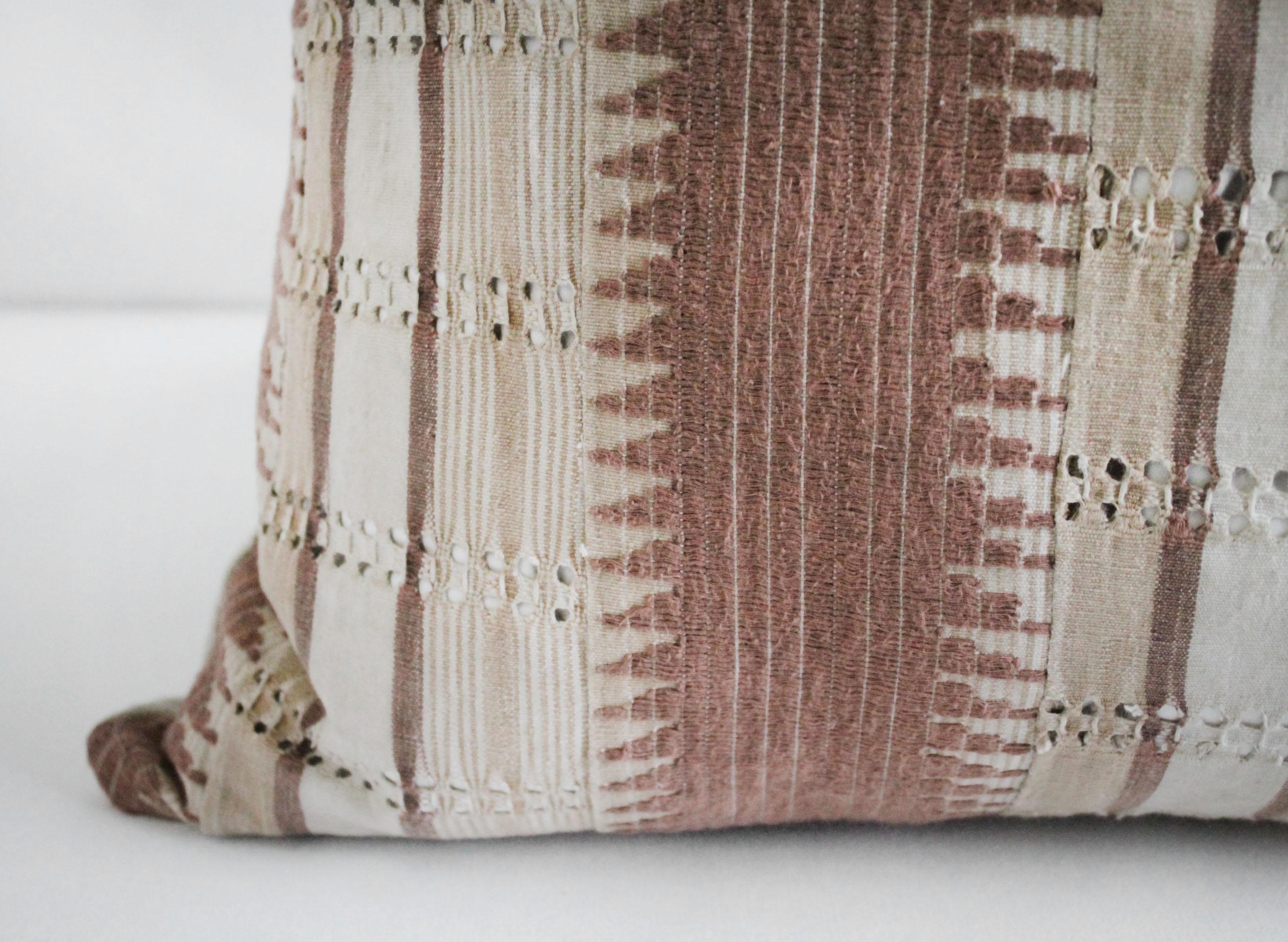 Vintage handmade tribal block linen lumbar pillow in blush mauve tones
The face in a full piece of antique tribal stripe and zig zag pattern in natural, cream, and dusty rose mauve tones.
The backside is 100% pure softened Irish linens. Our