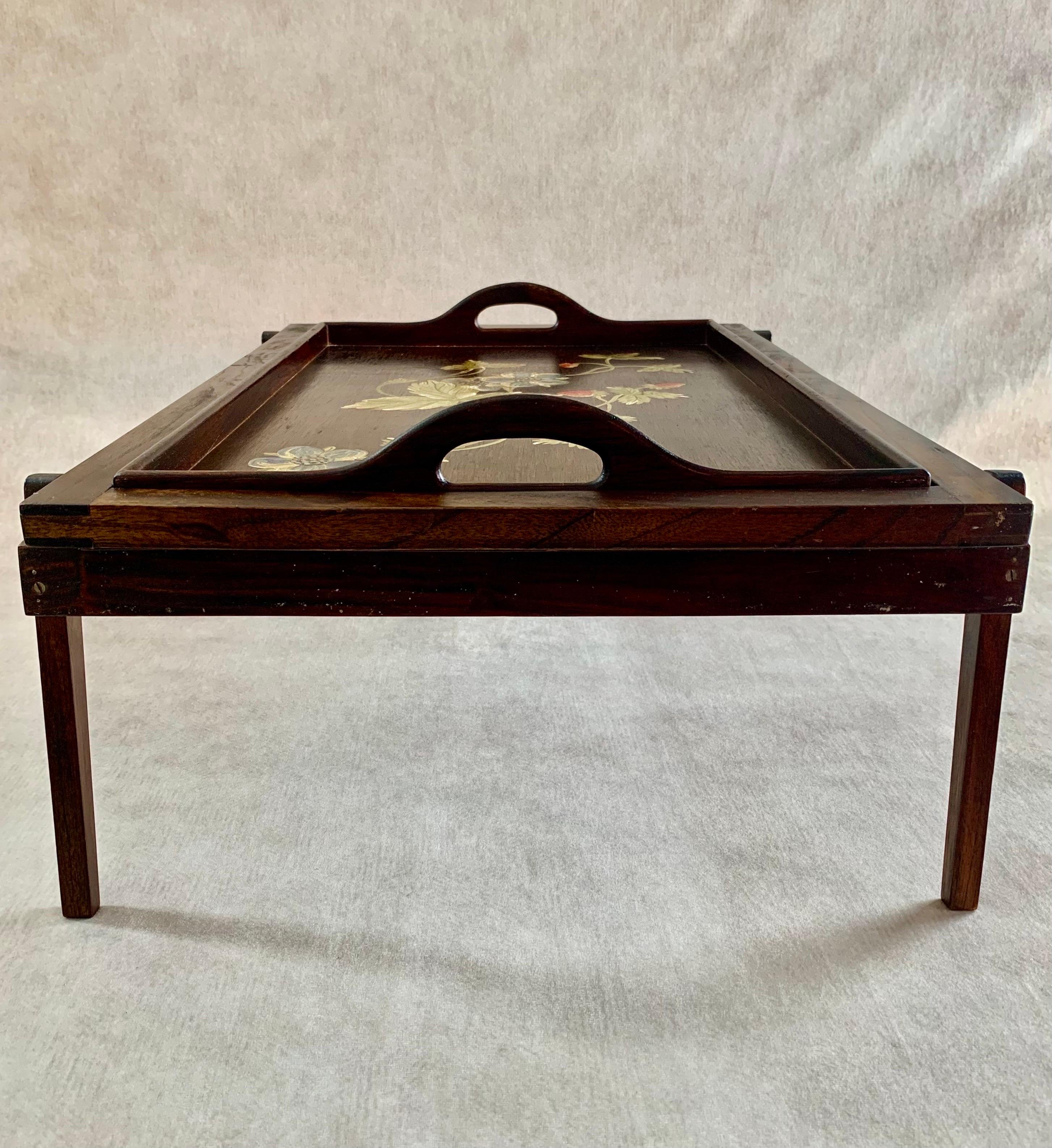 A beautifully hand-painted floral breakfast-in bed tray with removable stand crafted from Guanacaste and Mahogany woods native to Central America.  Made in El Salvador circa 1940.  

A unique vintage piece rich in culture perfect for leisurely