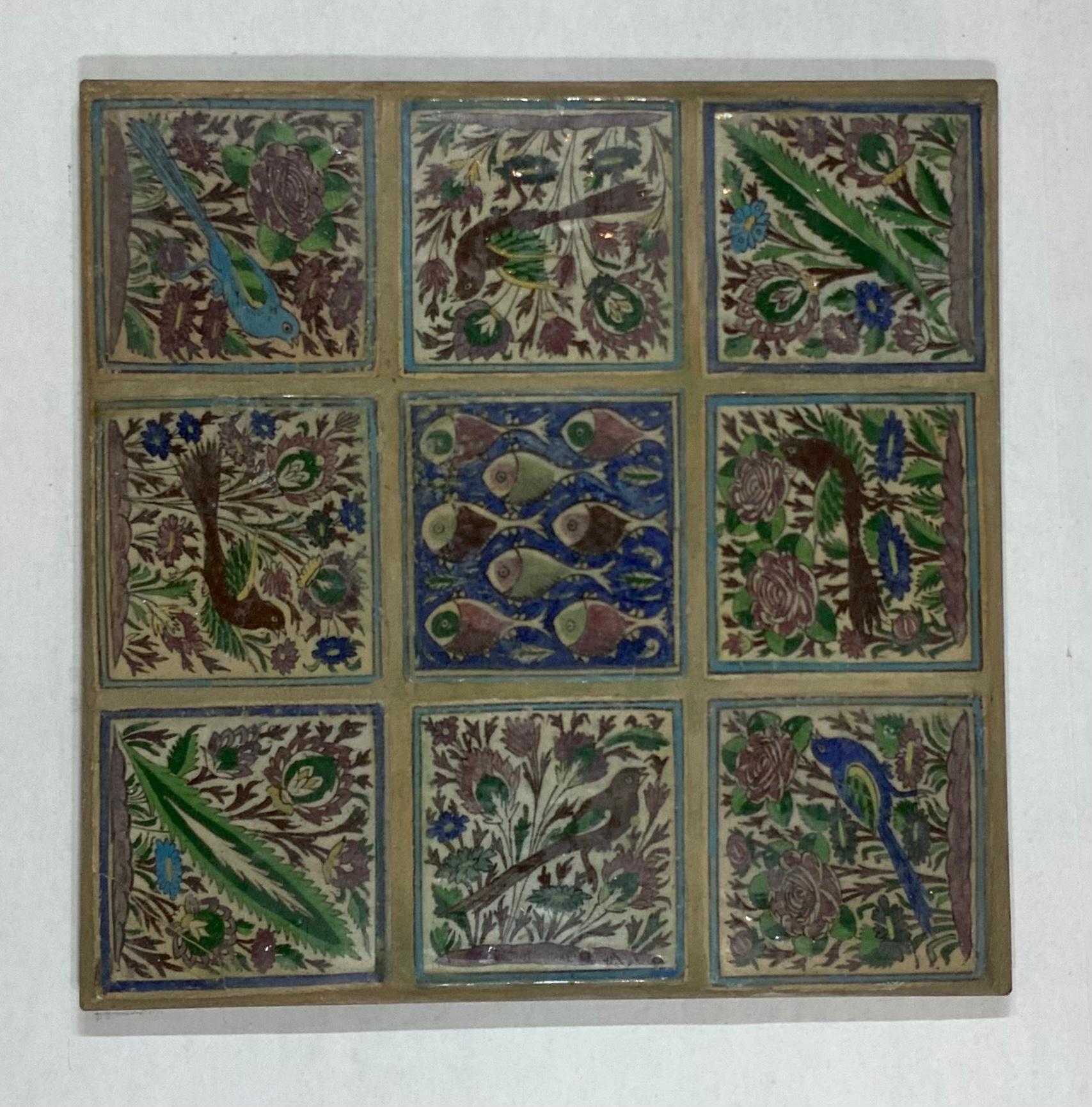 Exceptional Persian tile set of nine tiles with birds fish and flowers motifs, professionally mounted on custom made steel frame and backing. Some tiles are repaired see photo. Structurally very good condition.
Hooks in the back give options to