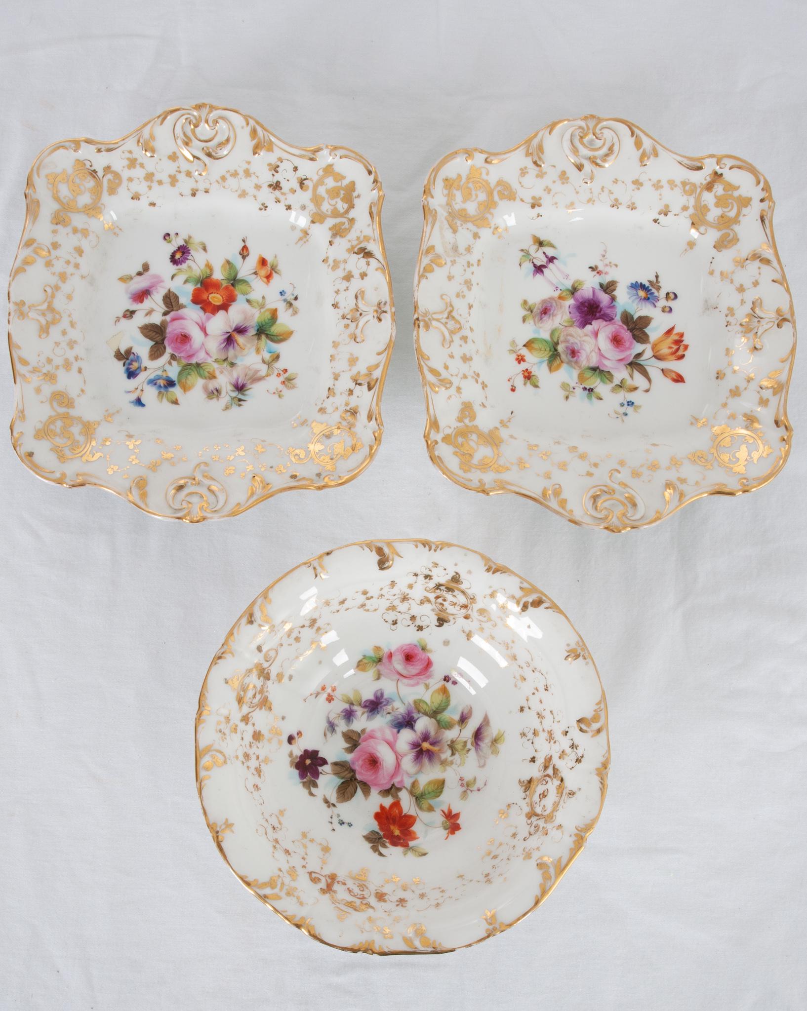 A beautiful set of three hand painted dishes to add a touch of sophistication to tea time! The elevated bowl measures 3-½”height x 8-?” diameter and the matching plates measure 1-?”H x 10-½”W x 9-?”D. A vibrant bouquet of delicately painted flowers