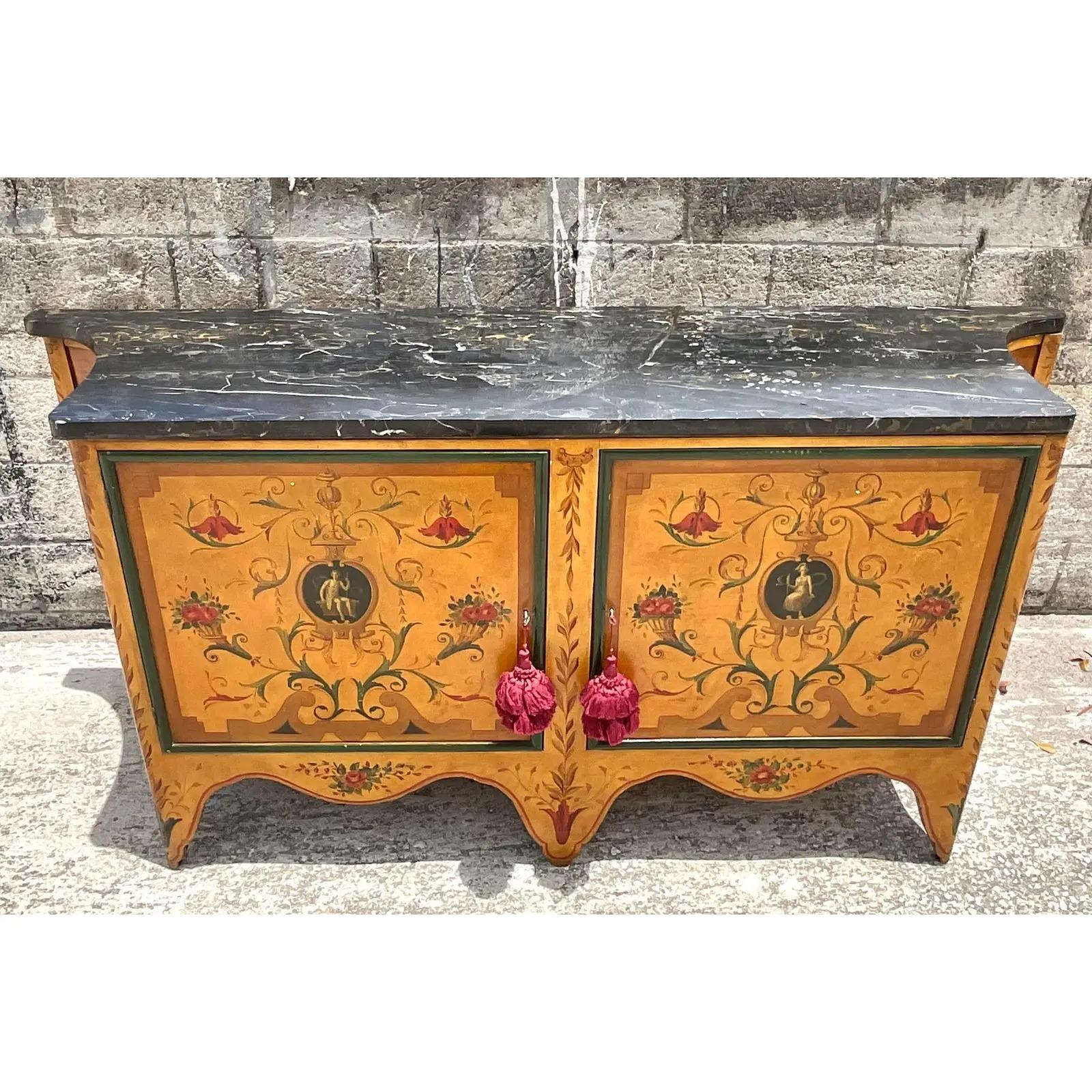 Stunning vintage hand painted credenza. Beautiful bold colors and a chic stone top. Lots of great storage below. Acquired from a Palm Beach estate.