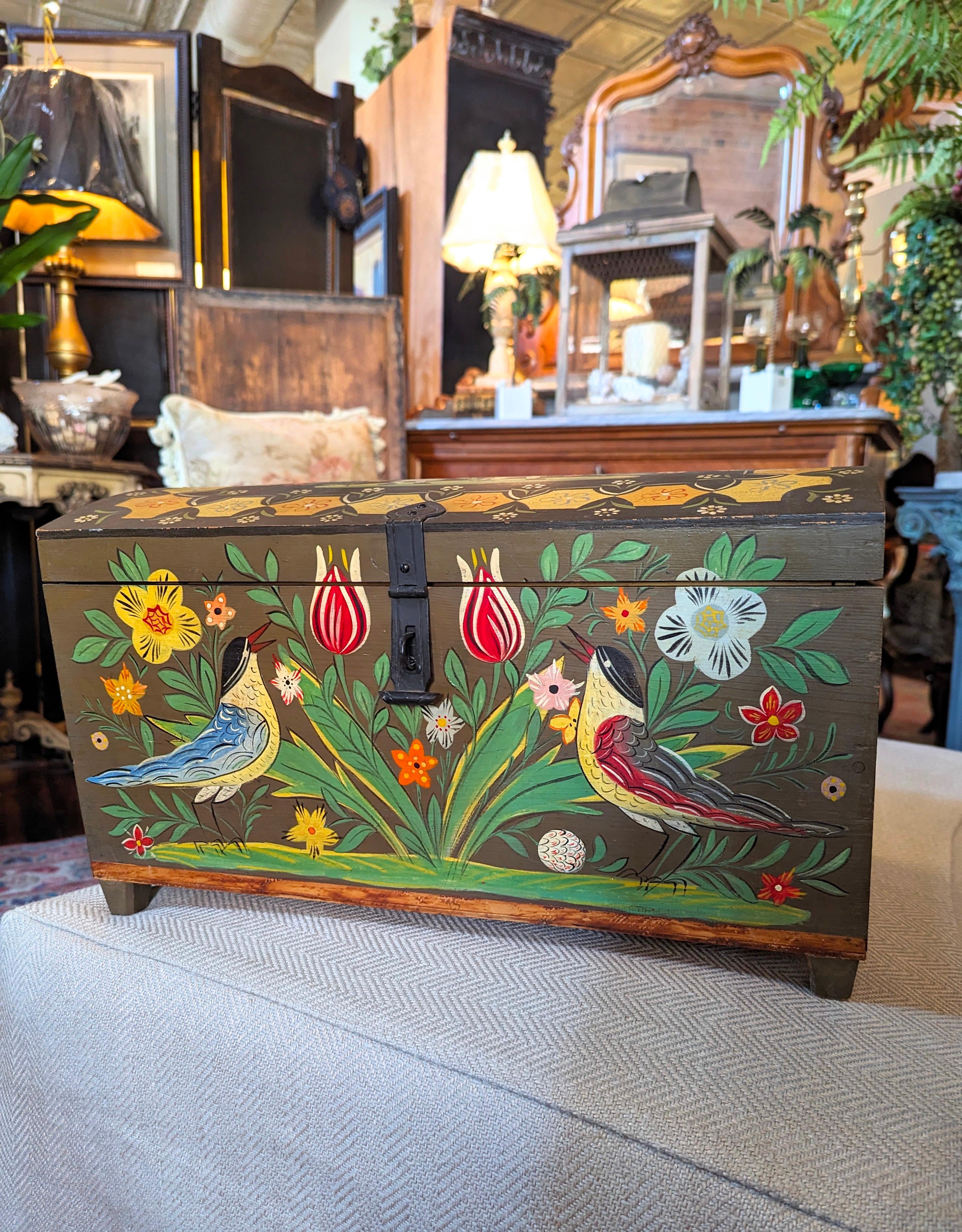 Vintage hand painted and hand crafted domed chest with an elaborate folk art scene throughout the entire box. Stunning artwork with florals, birds, and a courting scene on wood. This small to medium sized chest measures 16.5 inches in width by 9