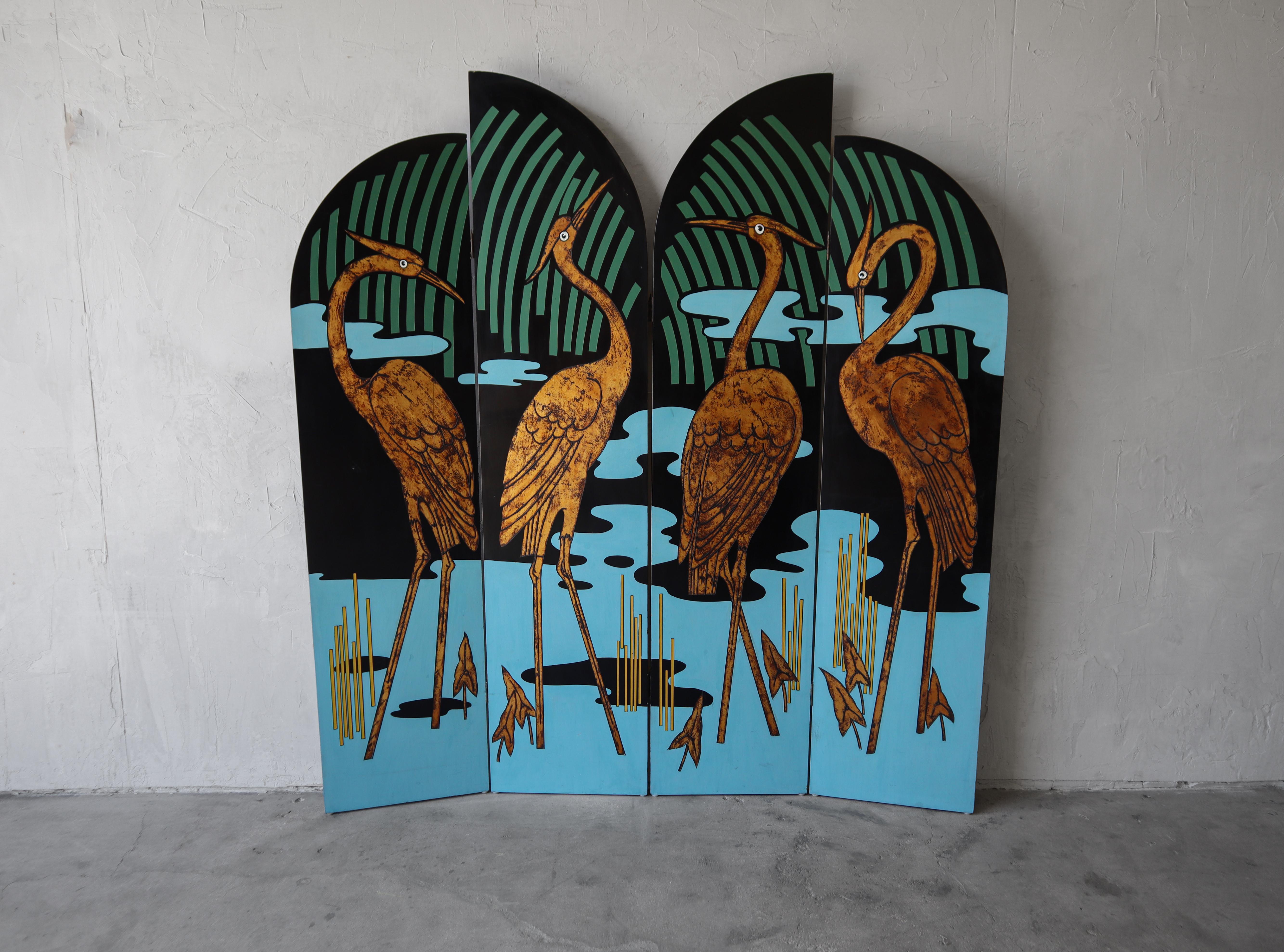 Absolutely stunning vintage, four panel Asian inspired screen room divider. The divider features four tiered, hand carved and hand painted wood panels displaying a gold leaf crane in pond scene on one side the other side is all black. The details on