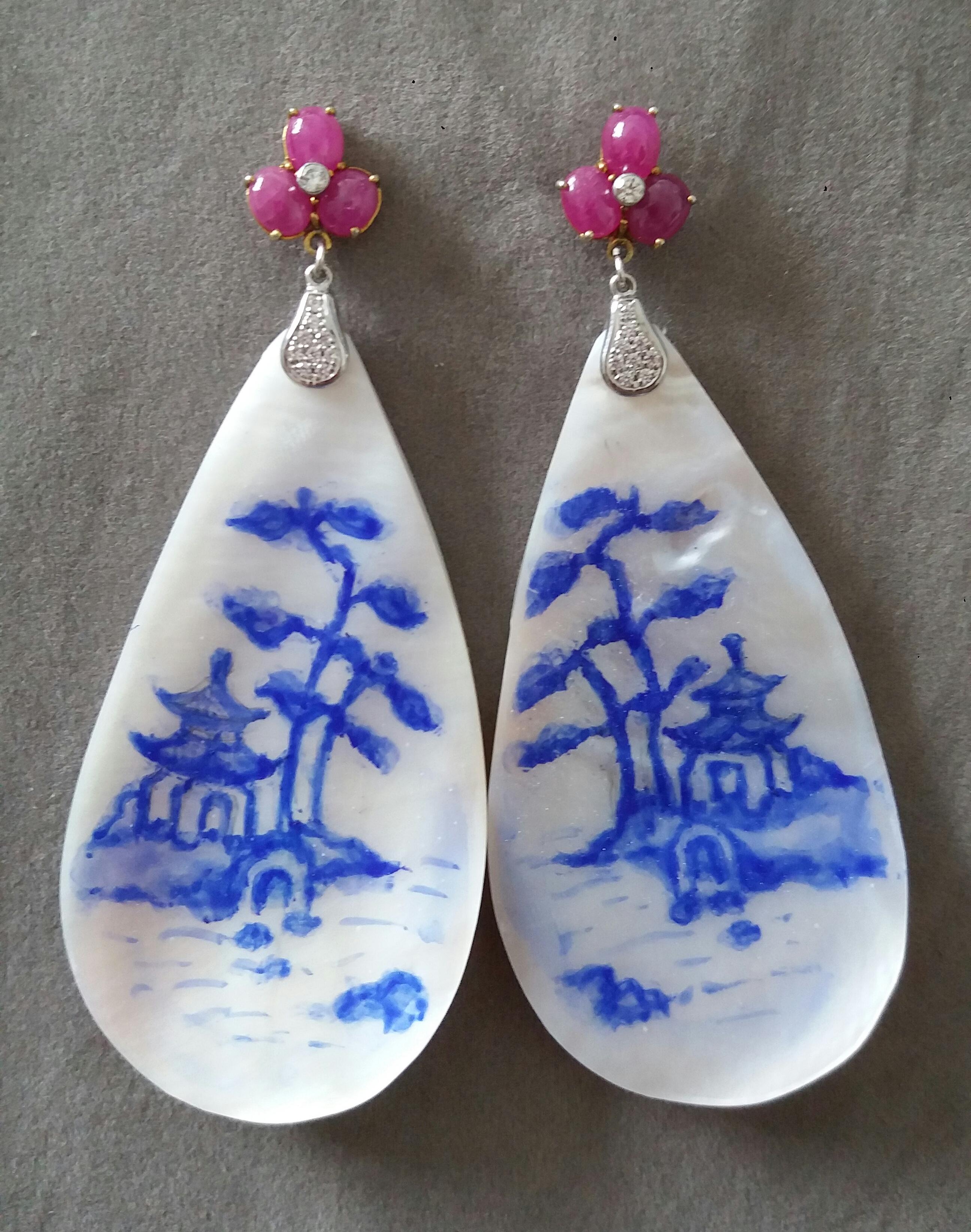 Vintage pair of hand painted pear shape Mother of Pearls  measuring 32x55 mm depicting a landscape with a chinese style house and a tree suspended from a top composed by 3 Oval Ruby Cabochons with a small diamond in the middle  by 2 elements in 14 K