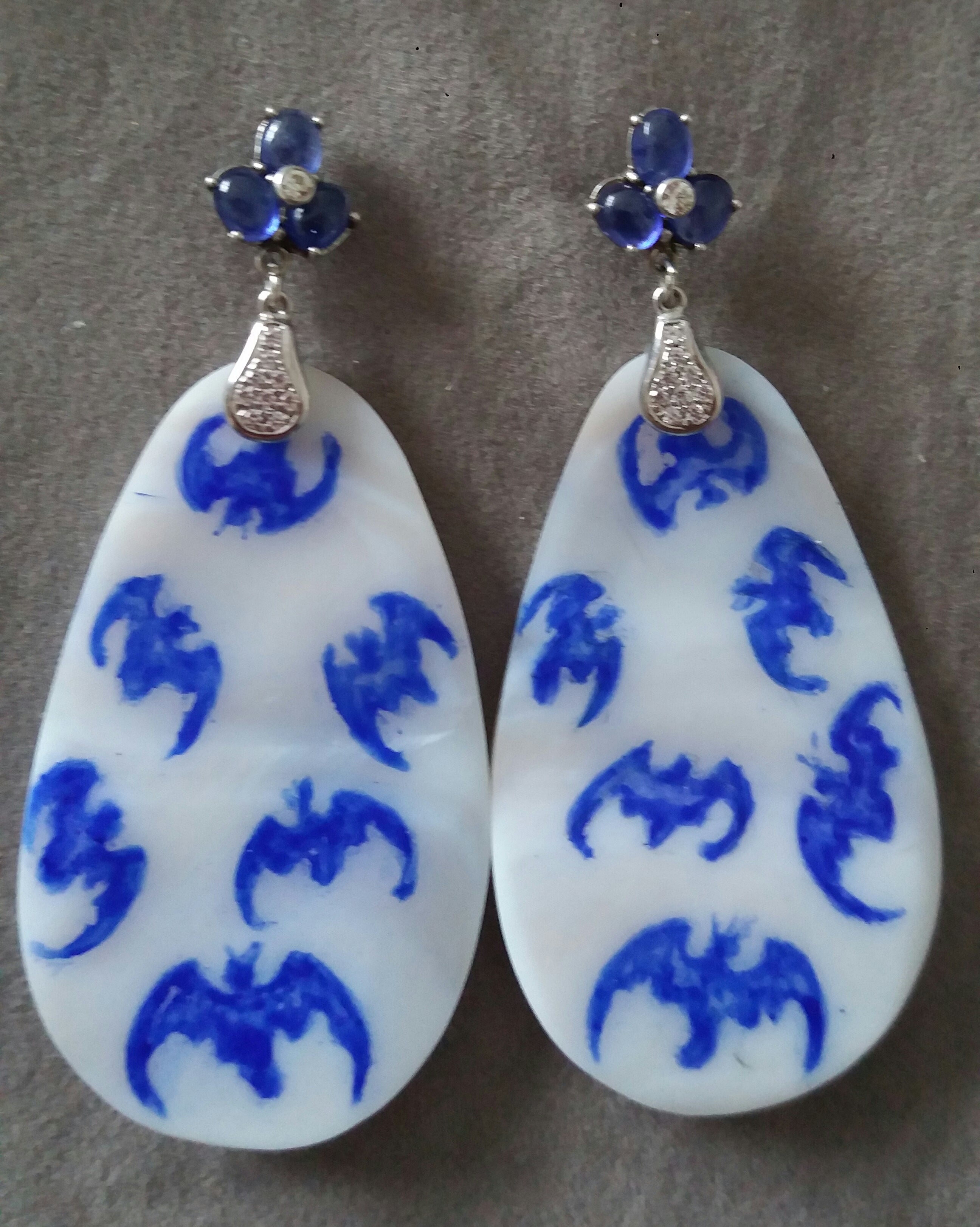 Vintage pair of hand painted pear shape Mother of Pearls  measuring 32x55 mm depicting a  ,flock of bats suspended from a top composed by 3 Blue Sapphires with a small diamond in the middle  by 2 elements in 14 K white gold and 16 small round