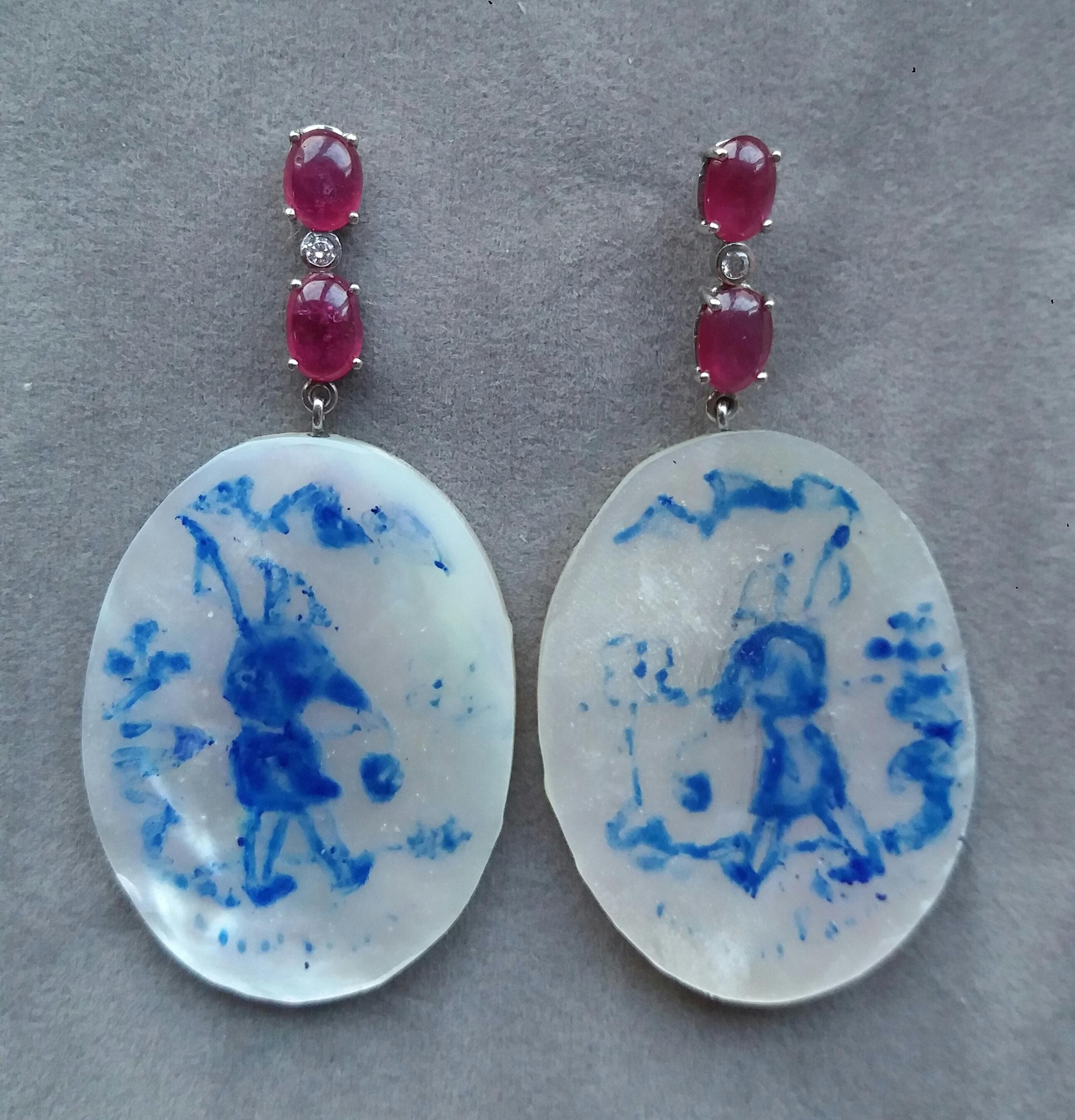 Vintage pair of oval shape hand painted Mother of Pearl measuring 28 mm x 40 mm, depicting a chinese fisherman walking near the river,suspended from a Gold bar with 2 oval Ruby cabs each measuring 4x5 mm with a small full cut diamond in the