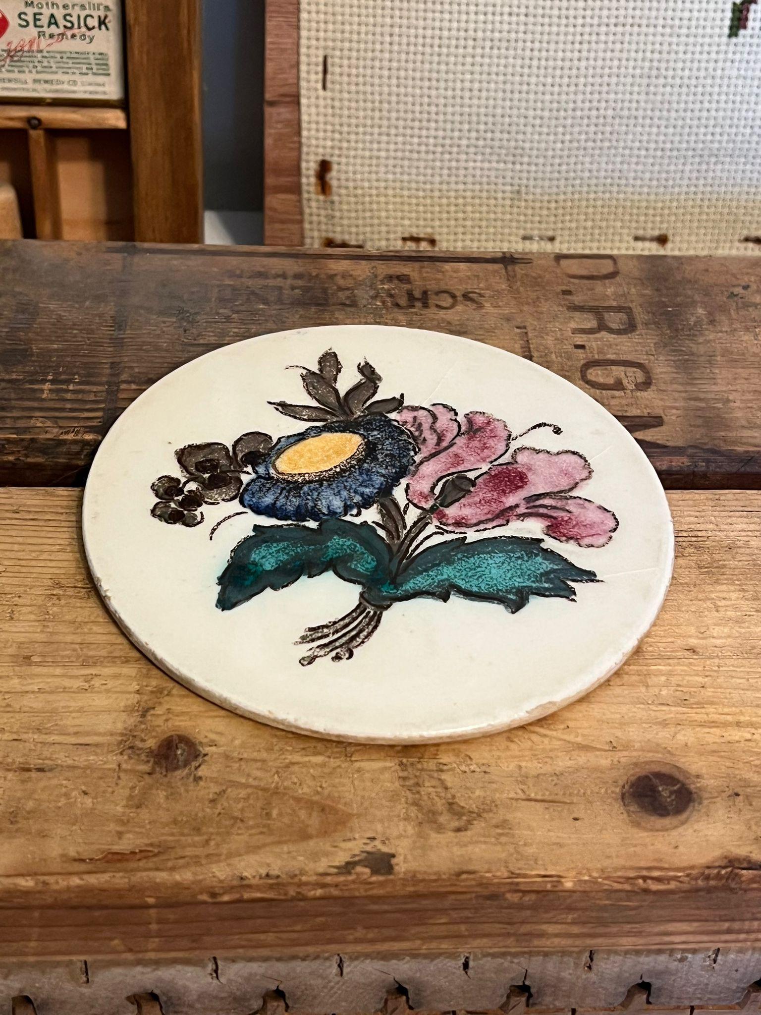 Round ceramic tile for decor or Coaster use.Beautiful vintage floral design. Hand Painted. Hairline crack throughout. Vintage Condition as pictured. Listing is for described item only.

Dimensions. 5.25” Diameter; 0.20”thick