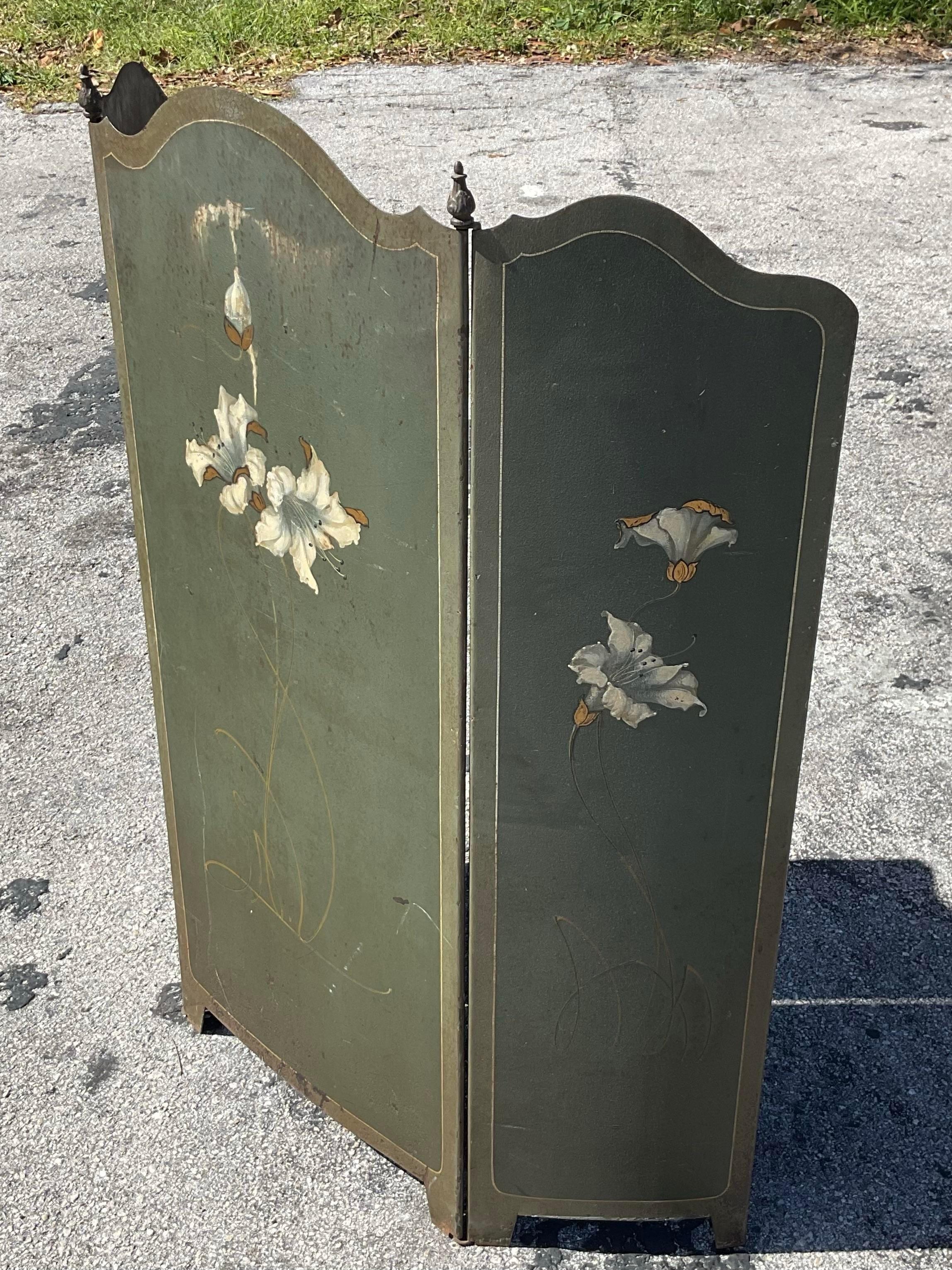 Fantastic tole hand painted fire screen. Beautiful deep green color with painted elegant white flowers and gold detailing trifold screen. Immediately add an element of elegance to any salon or sitting room. Acquired from a Palm Beach estate.