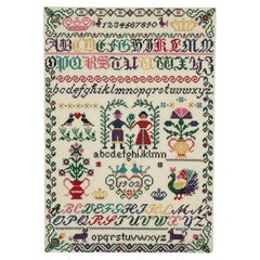 Vintage hand-stitched cross stitch alphabet sampler featuring multiple alphabet.
