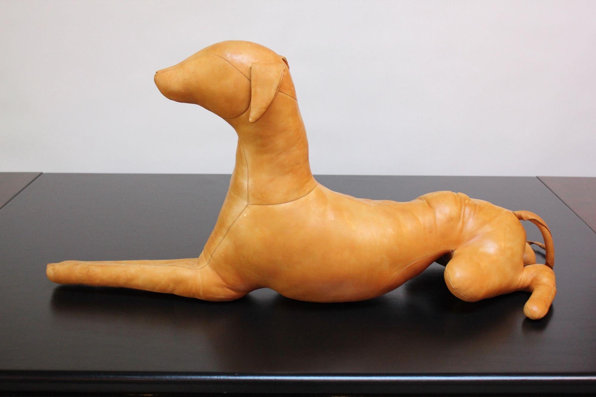 Buttery leather puppy dog sculpture in the Style of Dmitri Omersa (ca. 1980s, USA).
Very good, vintage condition with light patina/normal age consistent with age/use (due to the handmade construction and age, the dog does not lie flat and instead