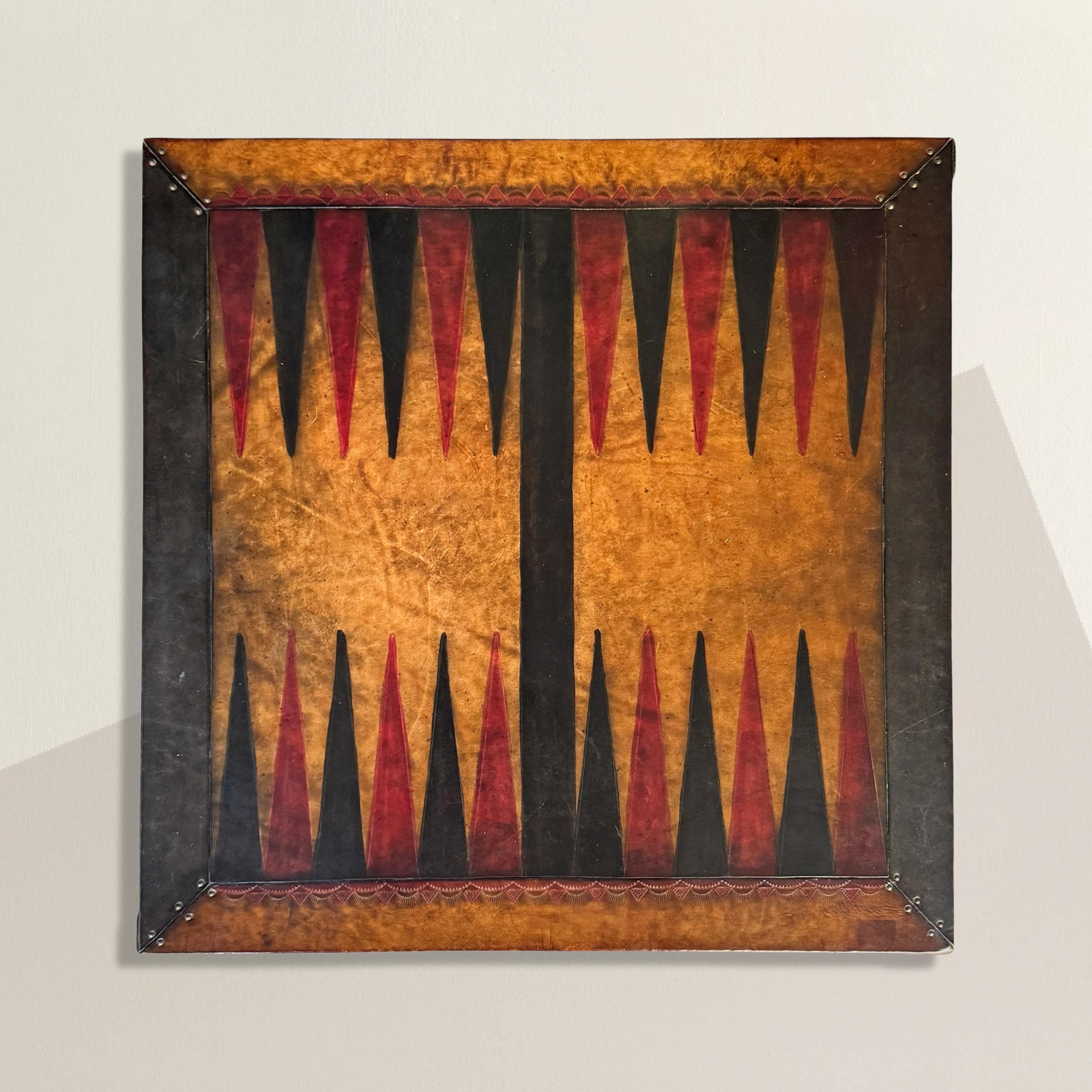 Game night just got a whole lot better. This vintage Mexican backgammon board is hand-tooled from warm, natural leather and full of personality. The playing surface pops with hand-painted red and black points, framed by bold alternating bands of